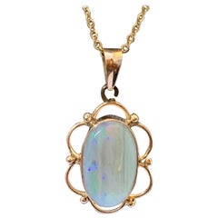 Natural opal pendant set in 14 Karat Yellow Gold