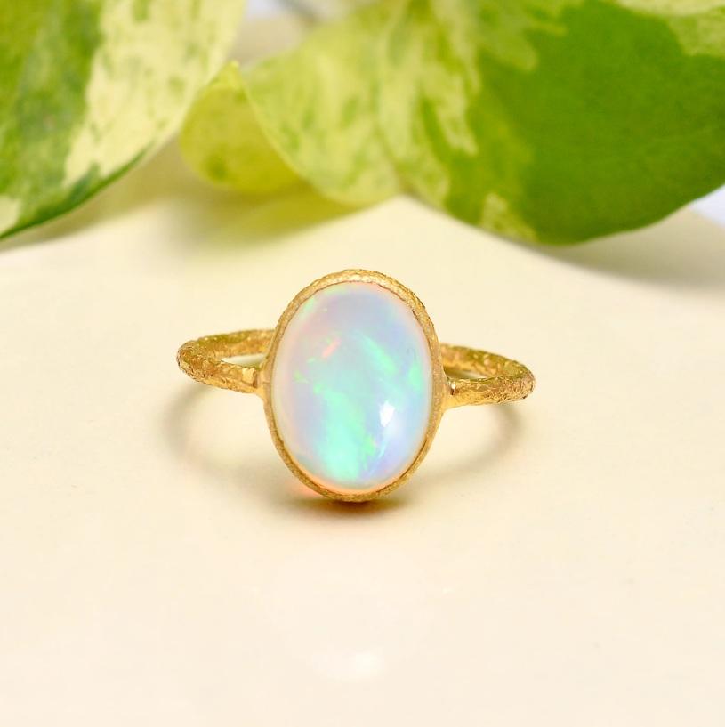 This ring is made of 18K yellow gold and features an opal gemstone. The ring is Classic and handcrafted and would make a great addition to any jewelry collection.

Specifications:

Dimensions: Ring Size-6.75 US, Top-13*9 MM
Gross Weight: 2.35