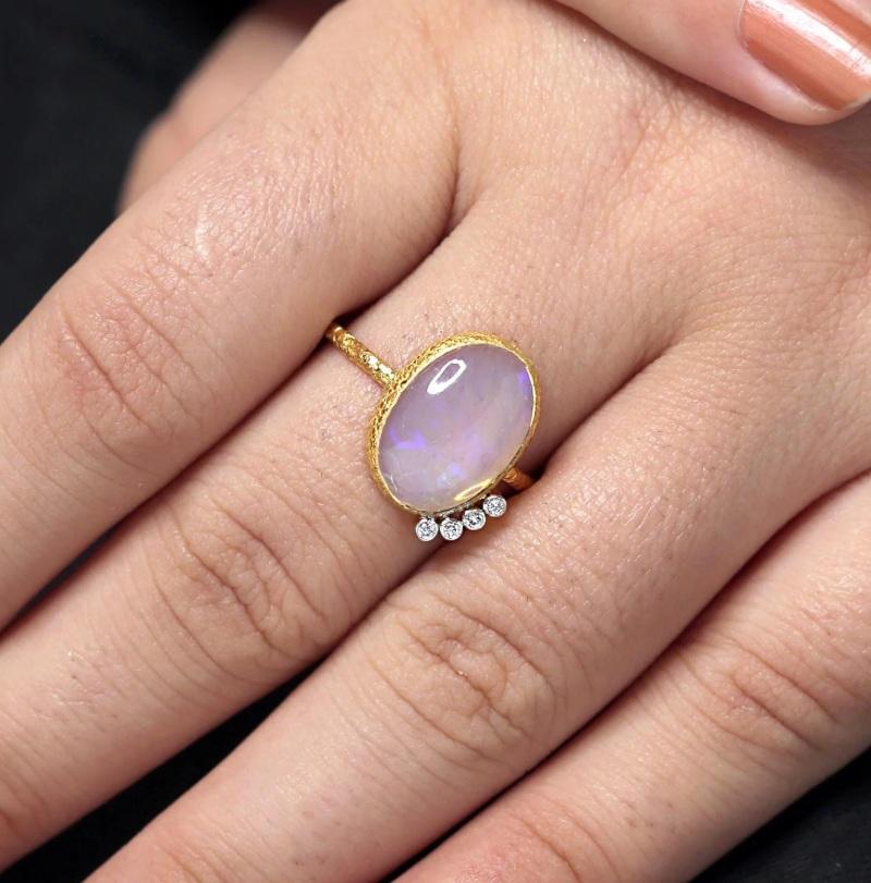 This textured ring is made of 18K yellow gold and features an opal gemstone. It is a beautiful and unique piece of jewelry that would make a great addition to any collection.

Specifications:

Dimensions: Ring Size-7.25, Top- 14*12 mm
Gross Weight: