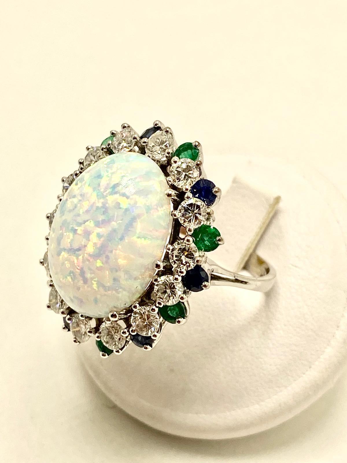 This magnificent ring showcases the enchanting beauty of a natural opal weighing 7.50 carats. The gemstone displays spectacular iridescent reflections, with flashes of vivid colors that shift and dance with the light. Known for its magical play of