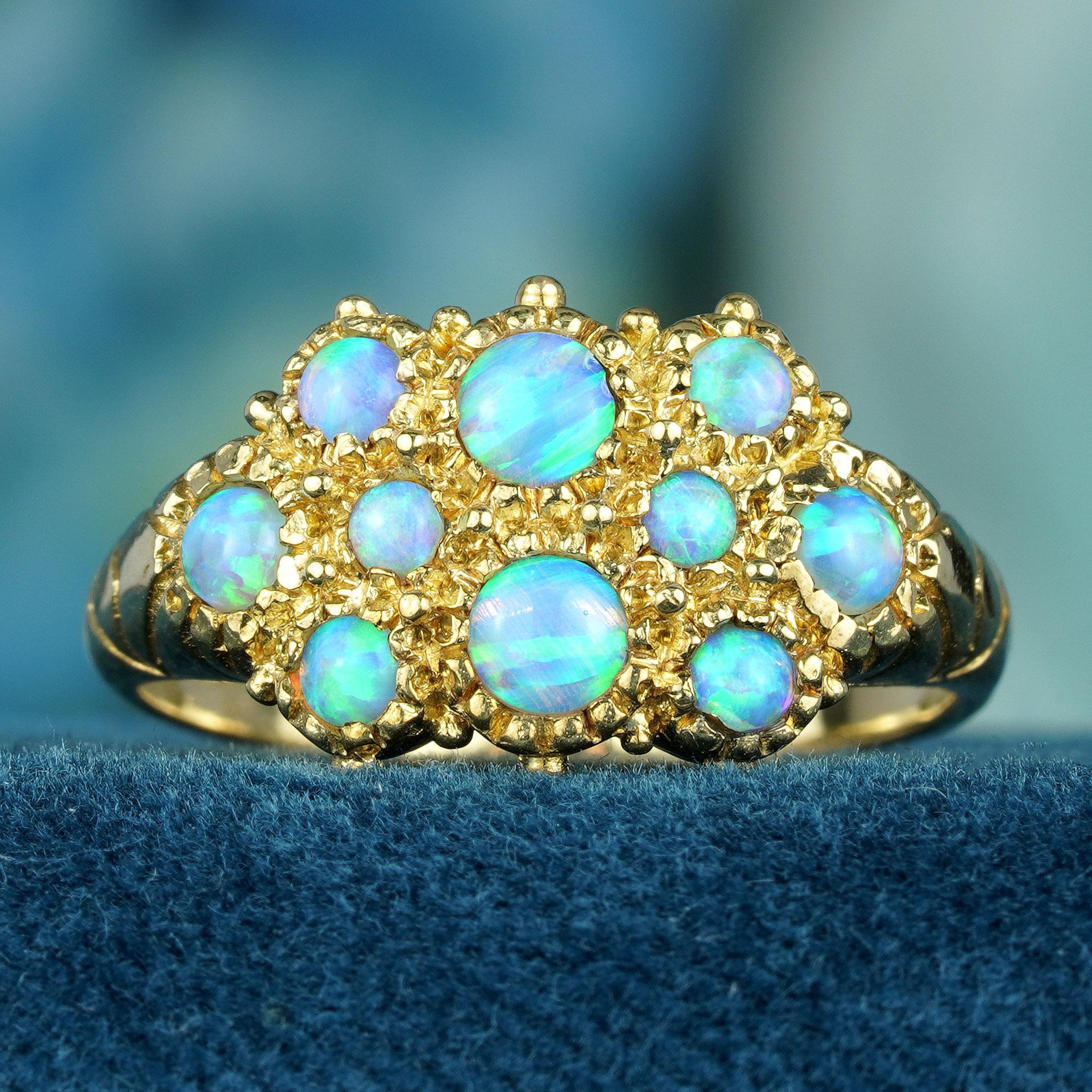 The ring showcases a cluster of natural opals set in solid yellow gold that curves gently upwards towards the milky white opal setting, creating a delicate and cool look. These round, white opals exhibit a variety of shades of milky white color,
