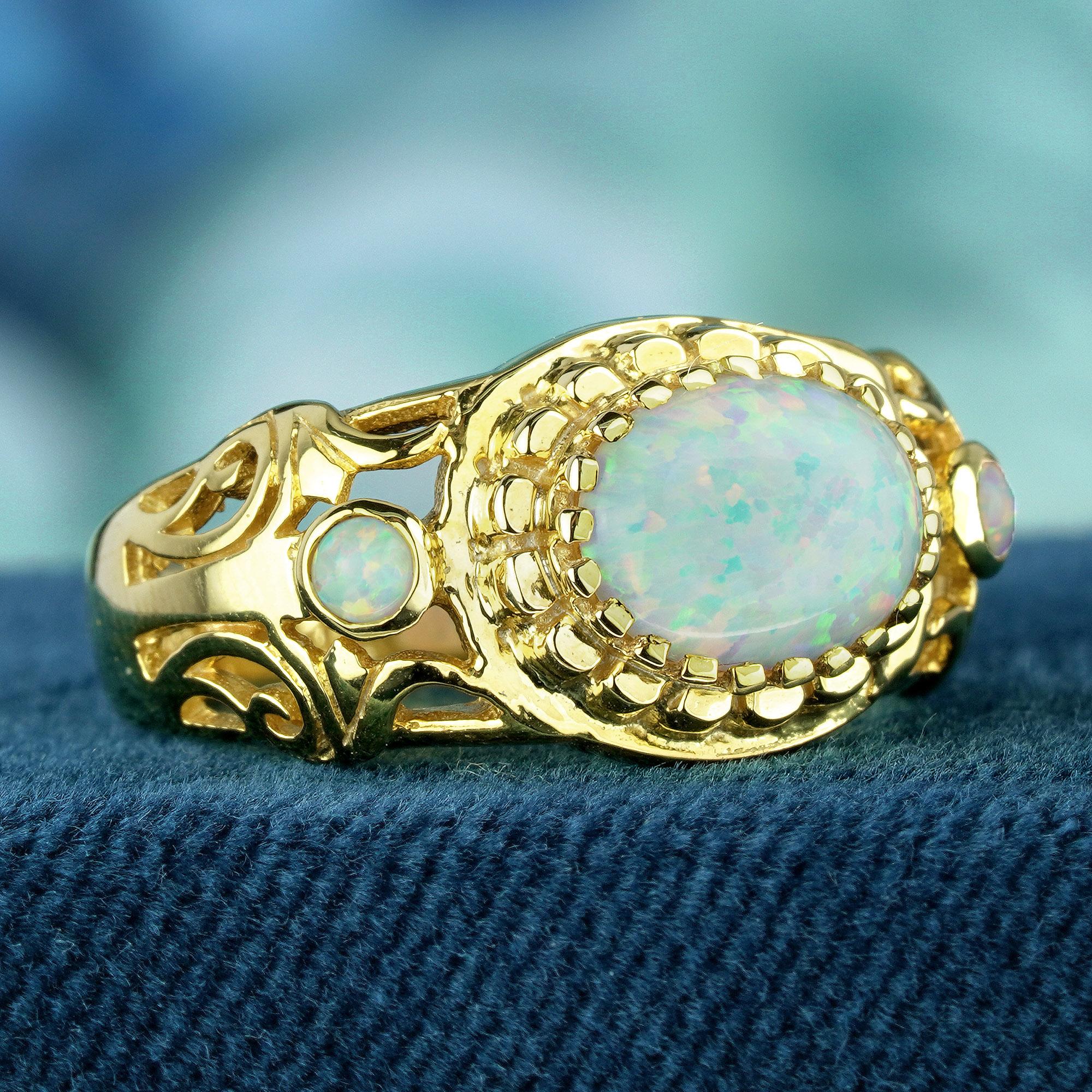 Elevate your elegance with a touch of vintage charm. Delight in the ethereal beauty of our vintage style ring, crafted in yellow gold. Featuring a stunning oval cabochon white opal as its centerpiece, complemented by round cabochon opal accents. The