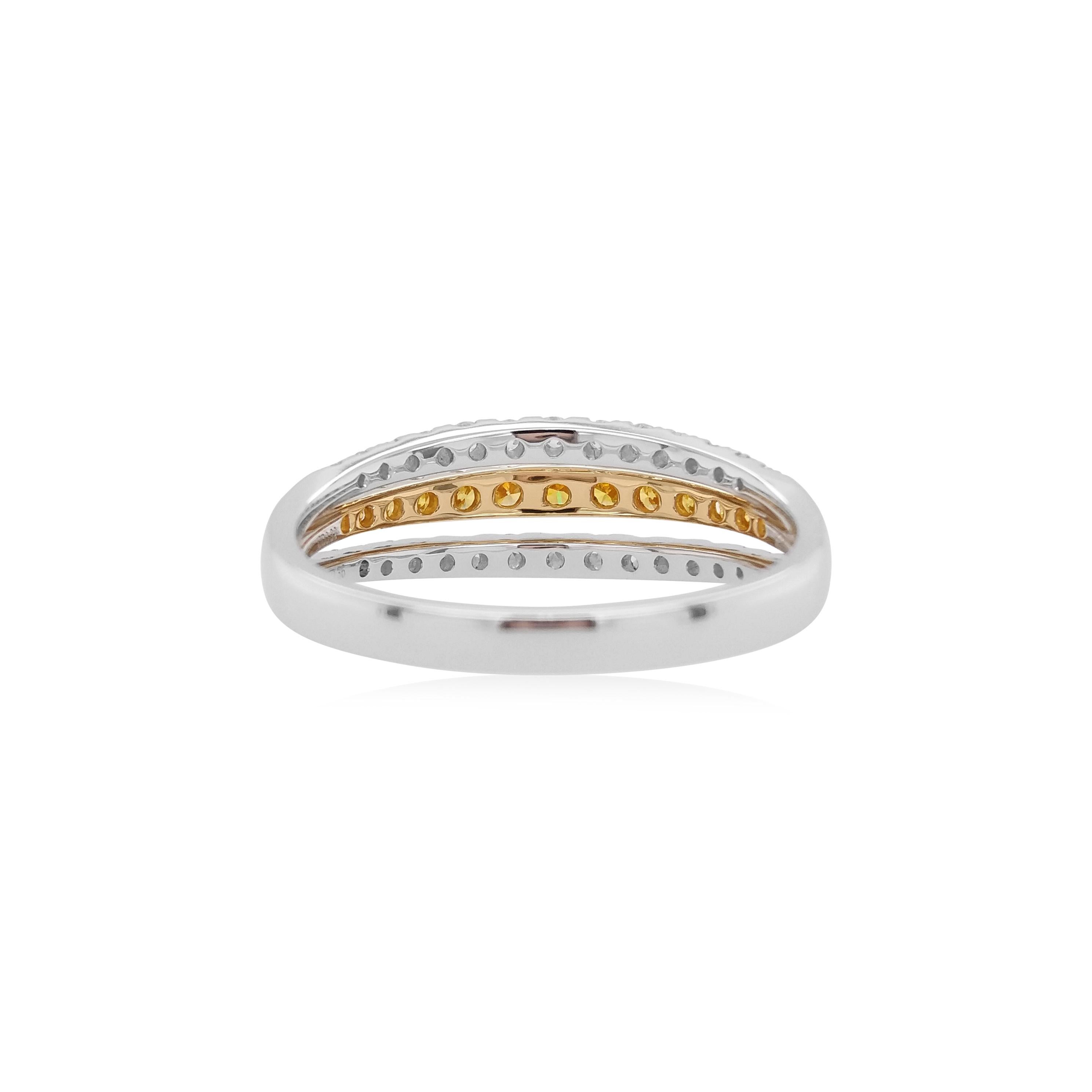 This subtle ring band features a row of scintillating Orange Diamonds at the center of its design. The impressive hues of the orange diamonds are perfectly accentuated by the 18 Karat white and yellow gold setting and sparkling white diamonds