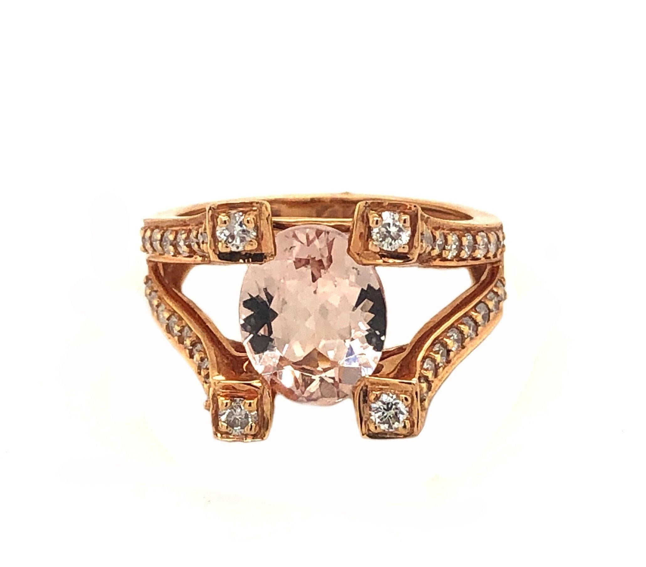 This is a marvelous natural 2.16ct morganite and diamond cocktail ring set in solid 14K rose gold. The natural Oval Morganite has an excellent peachy pink color and is set on top of a unique and curved pillared diamond encrusted shank. The ring is