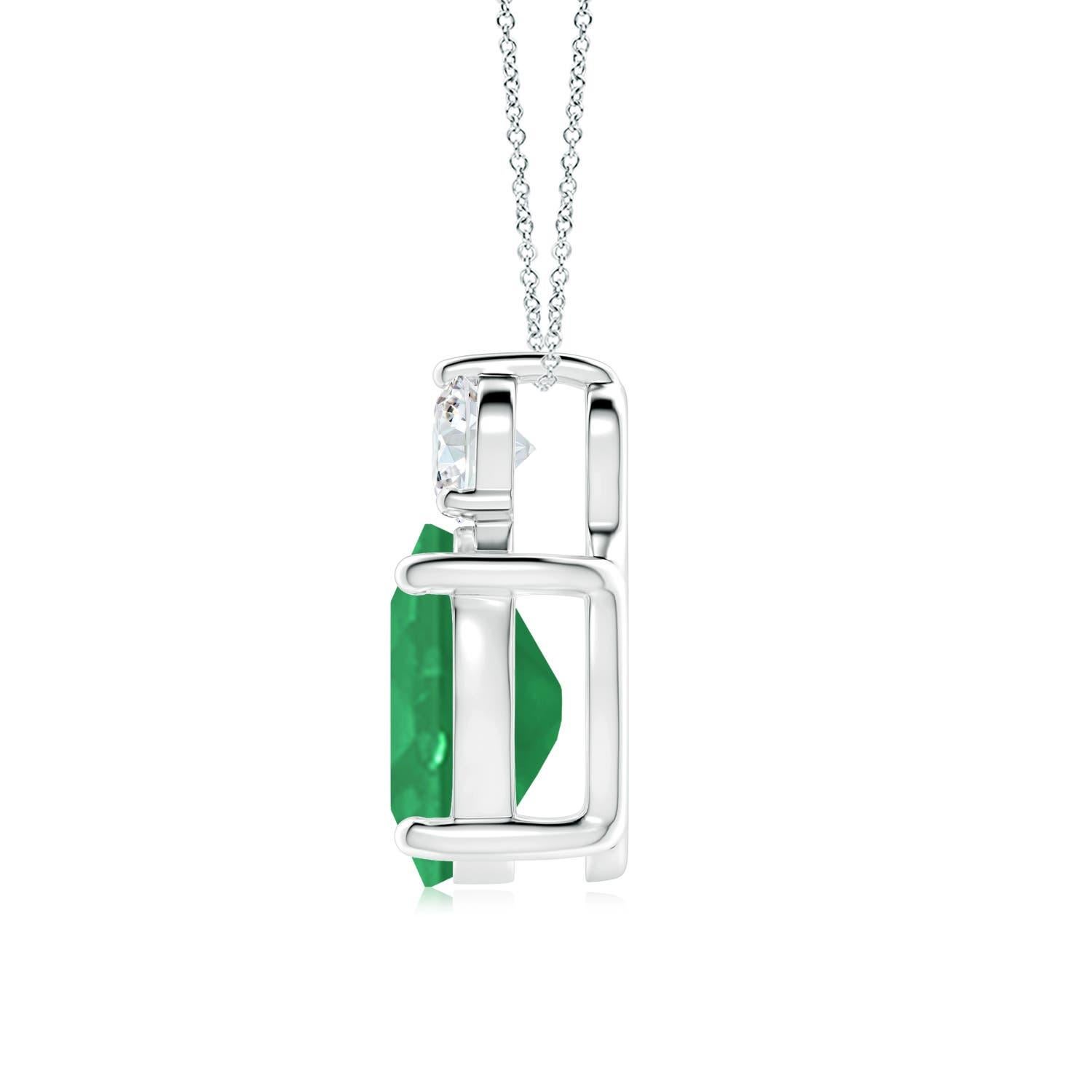 Crafted in 14k white gold, this classic solitaire emerald pendant personifies elegance. The rich green oval emerald is topped by a sparkling diamond for added allure. The intricate scroll work on the sides enhances this prong set emerald pendant's