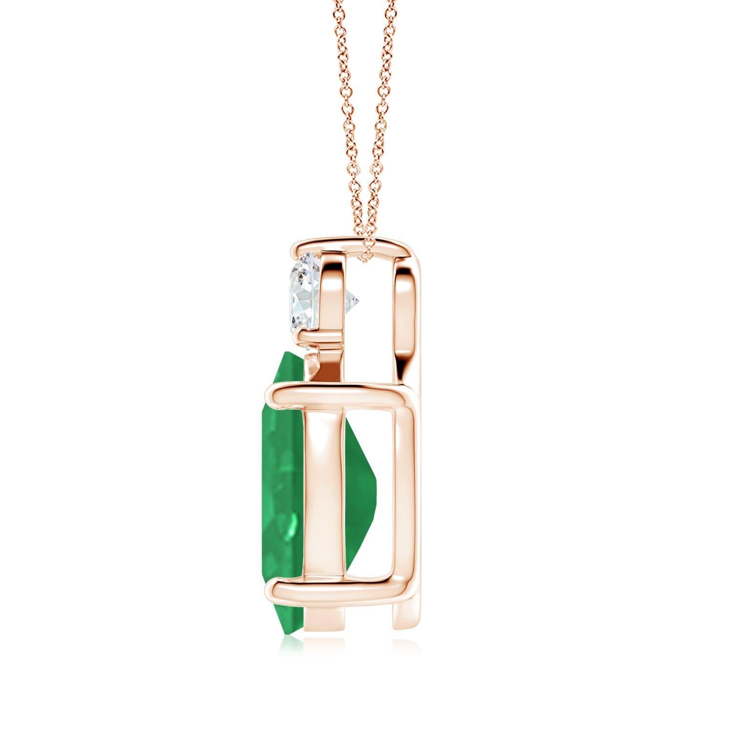 Crafted in 14k rose gold, this classic solitaire emerald pendant personifies elegance. The rich green oval emerald is topped by a sparkling diamond for added allure. The intricate scroll work on the sides enhances this prong set emerald pendant's