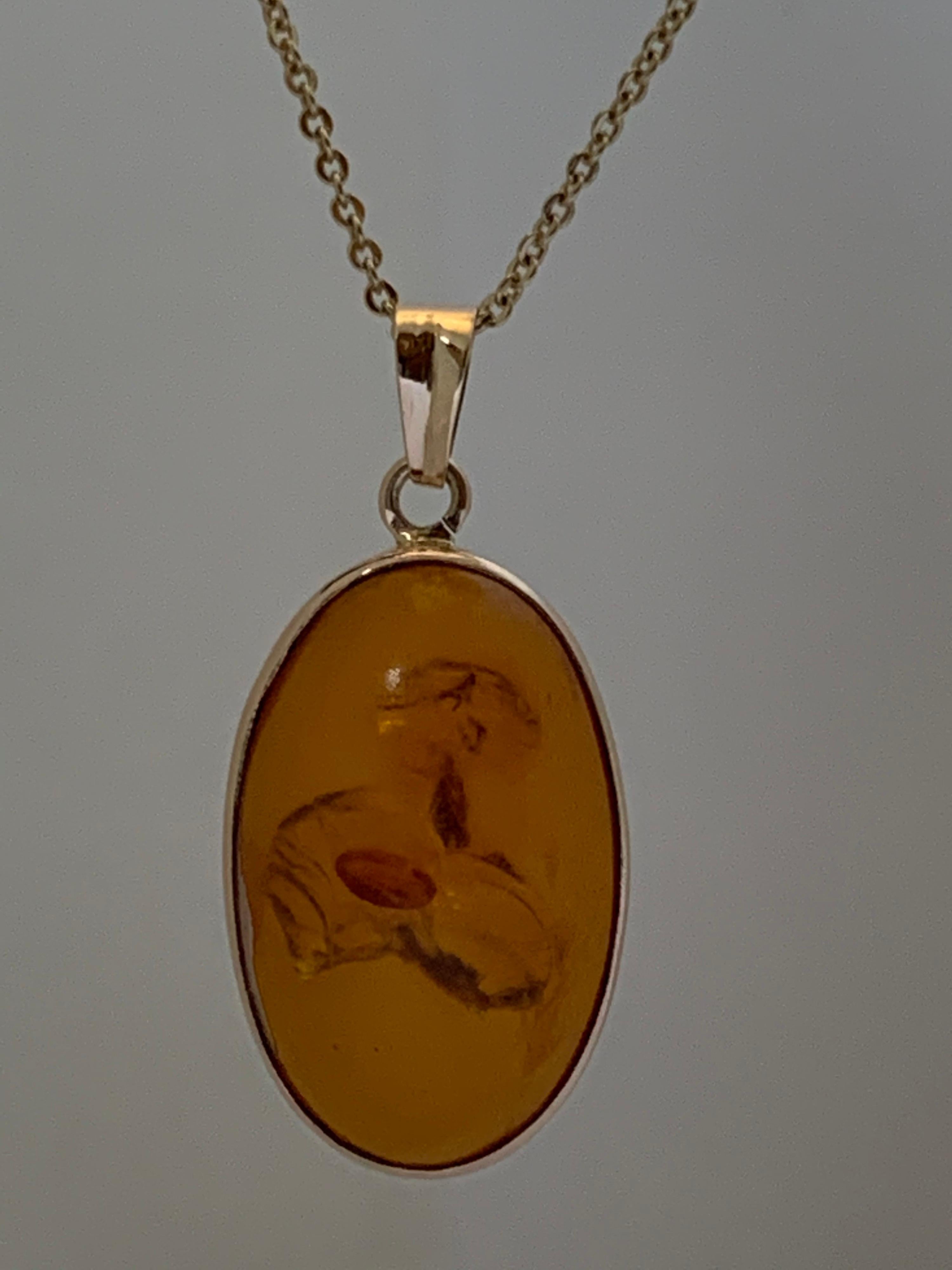 Contemporary Natural Oval Amber Set in 14 Karat Gold For Sale