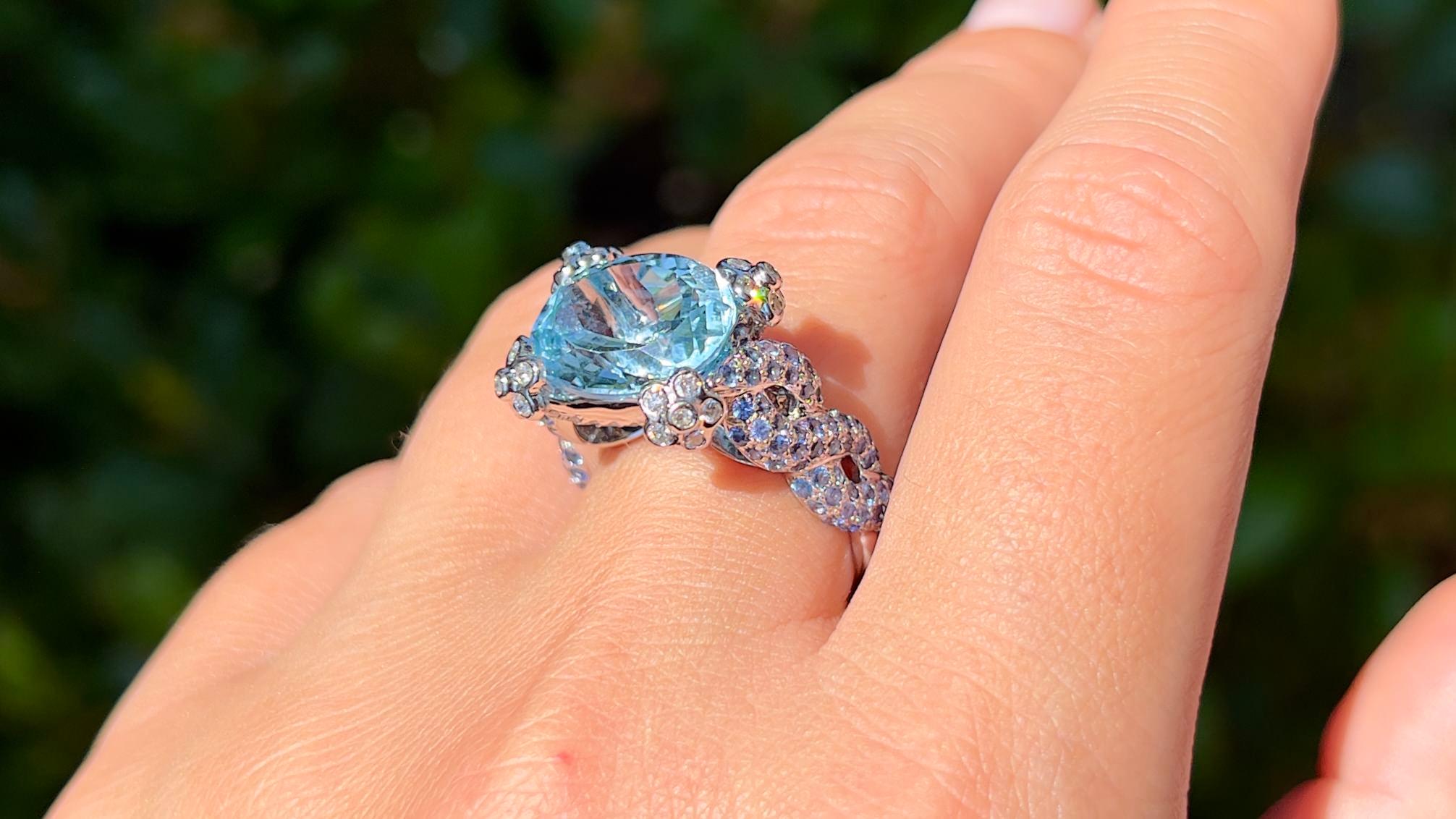 It comes with the Gemological Appraisal by GIA GG/AJP
All Gemstones are Natural
Aquamarine = 5.88 Carats
Cut: Oval
Blue Sapphires = 1.27 Carats
Cut: Round
Diamonds = 0.64 Carats
Cut: Round, Color: F, Clarity: VS
Metal: 18K White Gold
Ring Size: