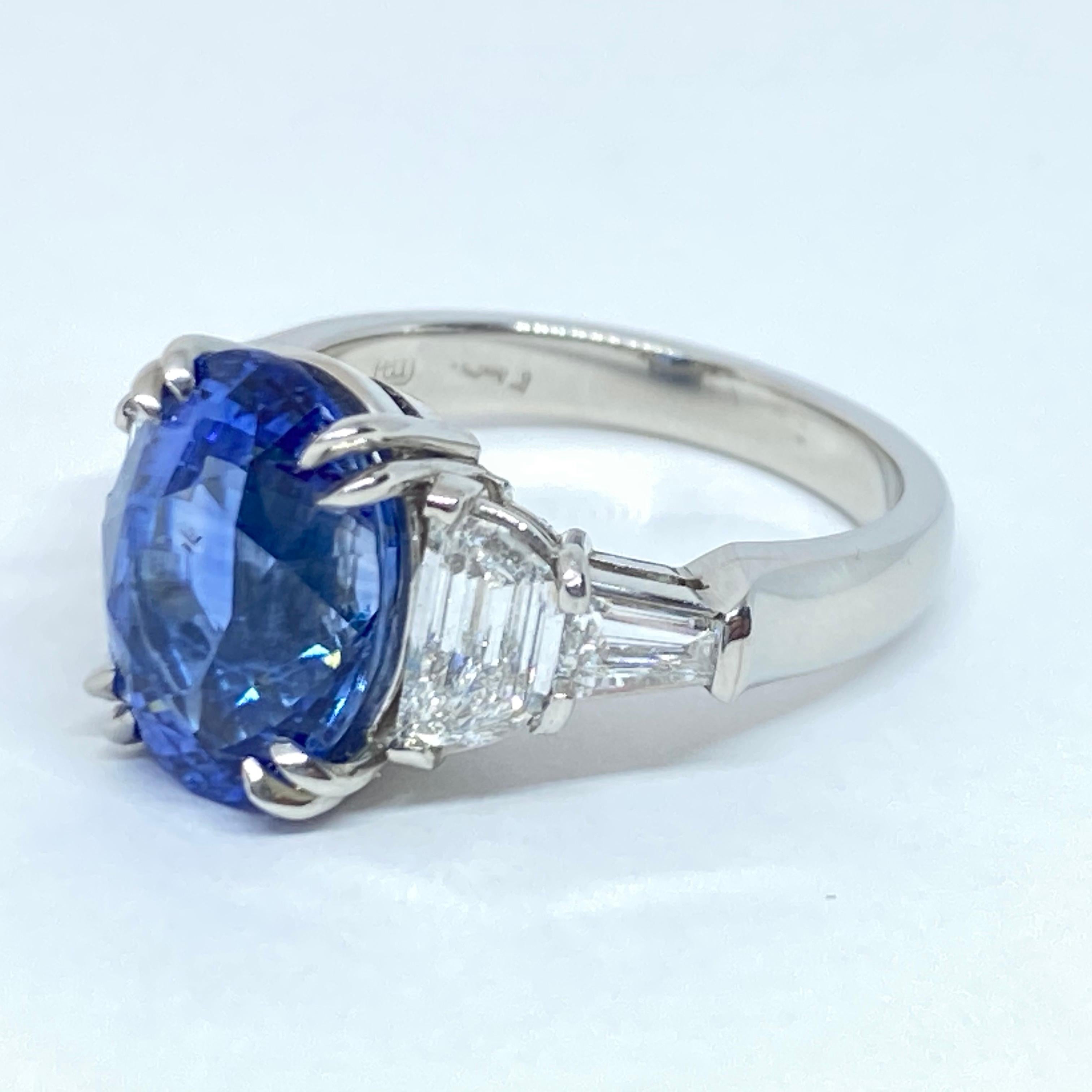 This is a gorgeous natural cornflower blue sapphire and diamond ring designed in a handmade custom solid platinum mounting. The center is a fancy oval cut sapphire measuring 12.17 X 9.53 X 7.88mm with a weight of 7.11 carats! The sapphire is a