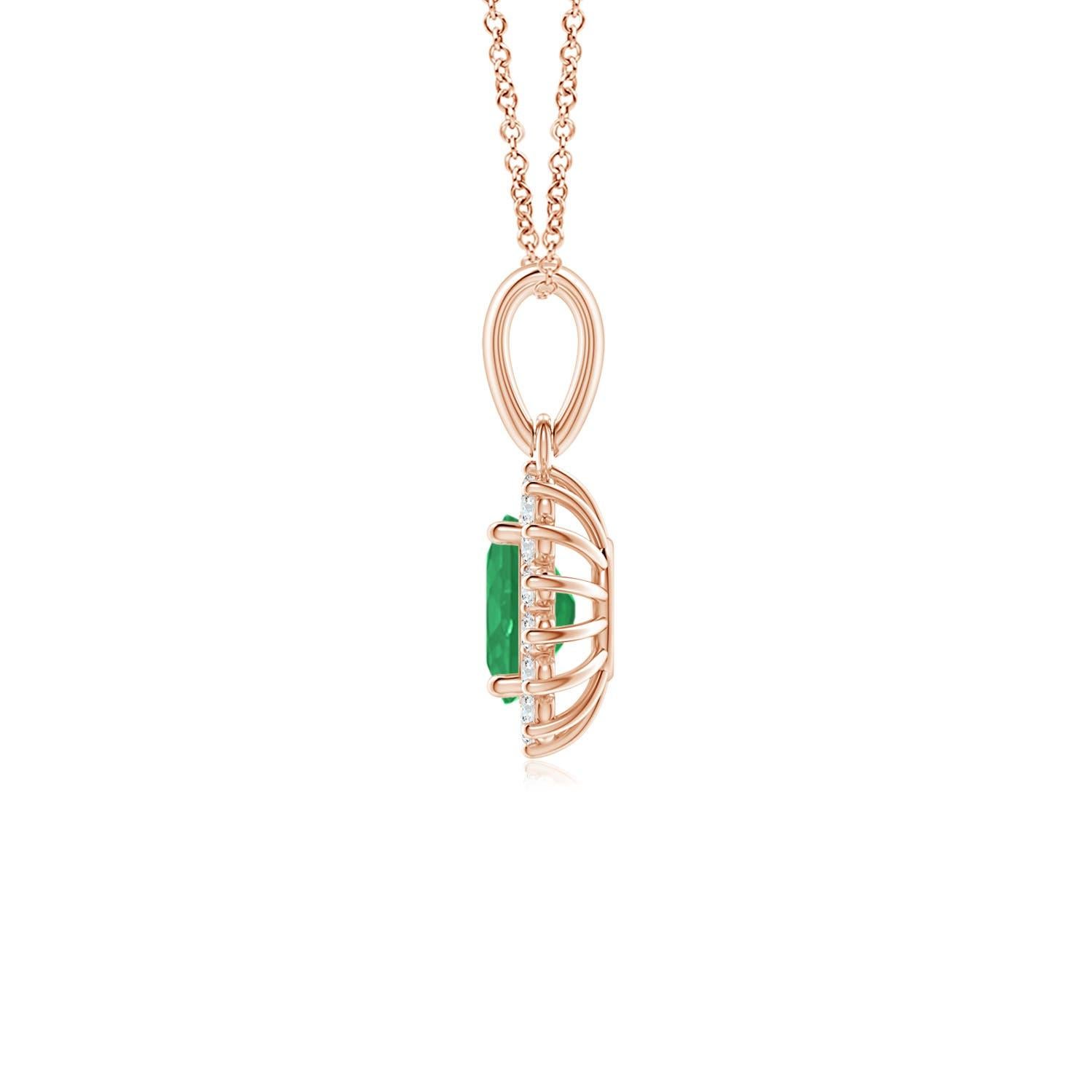 This enchanting emerald and diamond halo dangle pendant will steal hearts with its exquisiteness. An oval lush green emerald at the center is surrounded by sparkling white diamonds to create a beautiful floral design. Sculpted in 14k rose gold, this