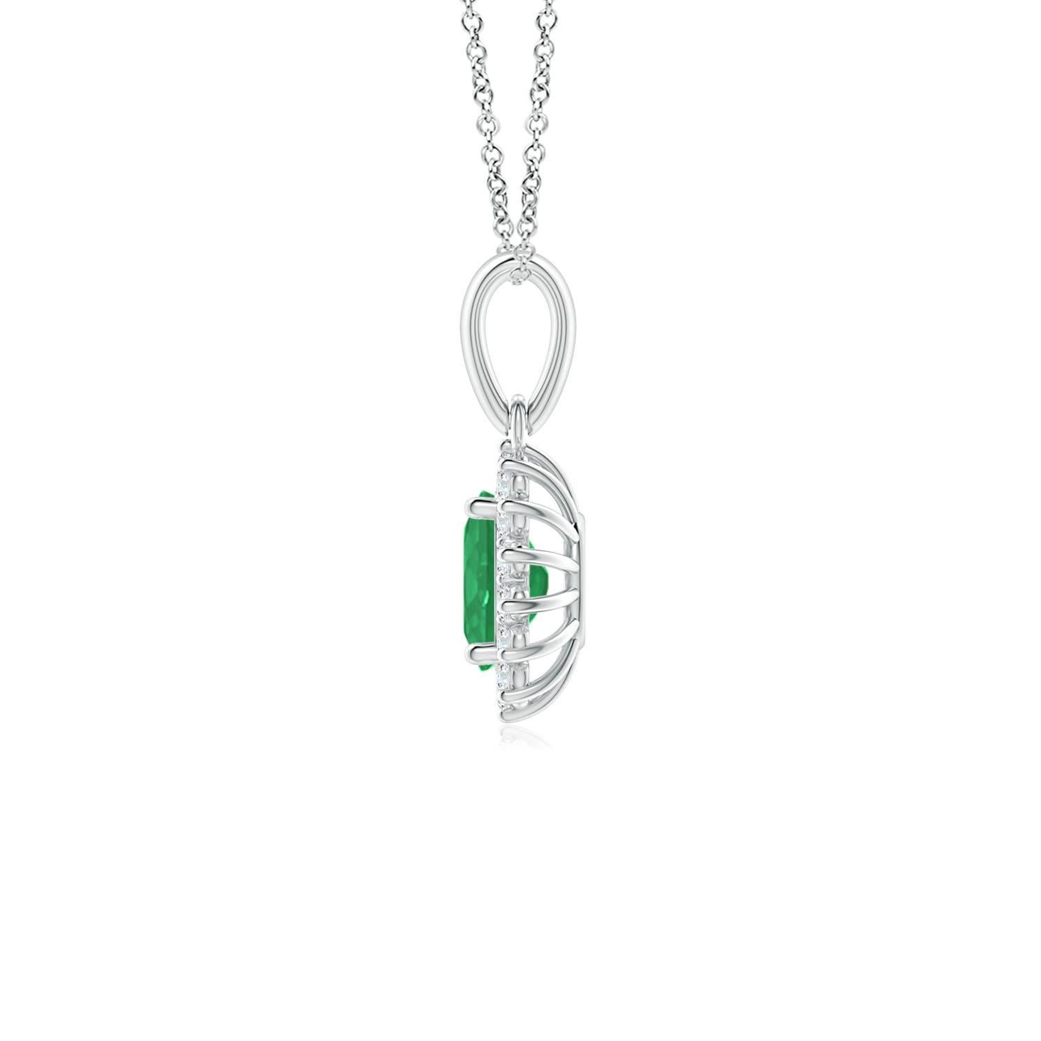 This enchanting emerald and diamond halo dangle pendant will steal hearts with its exquisiteness. An oval lush green emerald at the center is surrounded by sparkling white diamonds to create a beautiful floral design. Sculpted in 14k white gold,