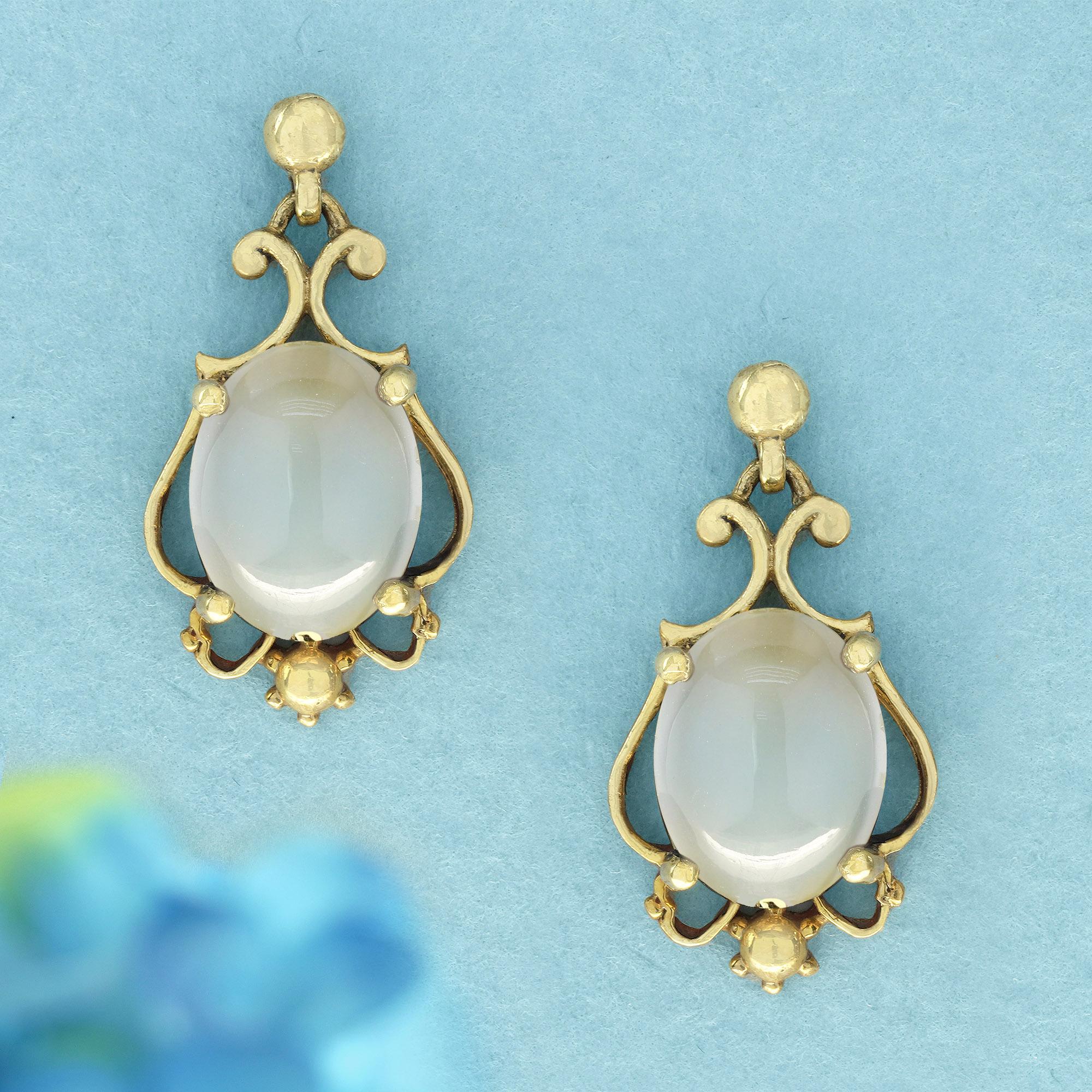 These natural cabochon moonstone vintage style drop earrings in solid yellow gold are not just for show; they are crafted with a sense of purpose and style, making them perfect for adding a touch of sophistication to your everyday outfits or