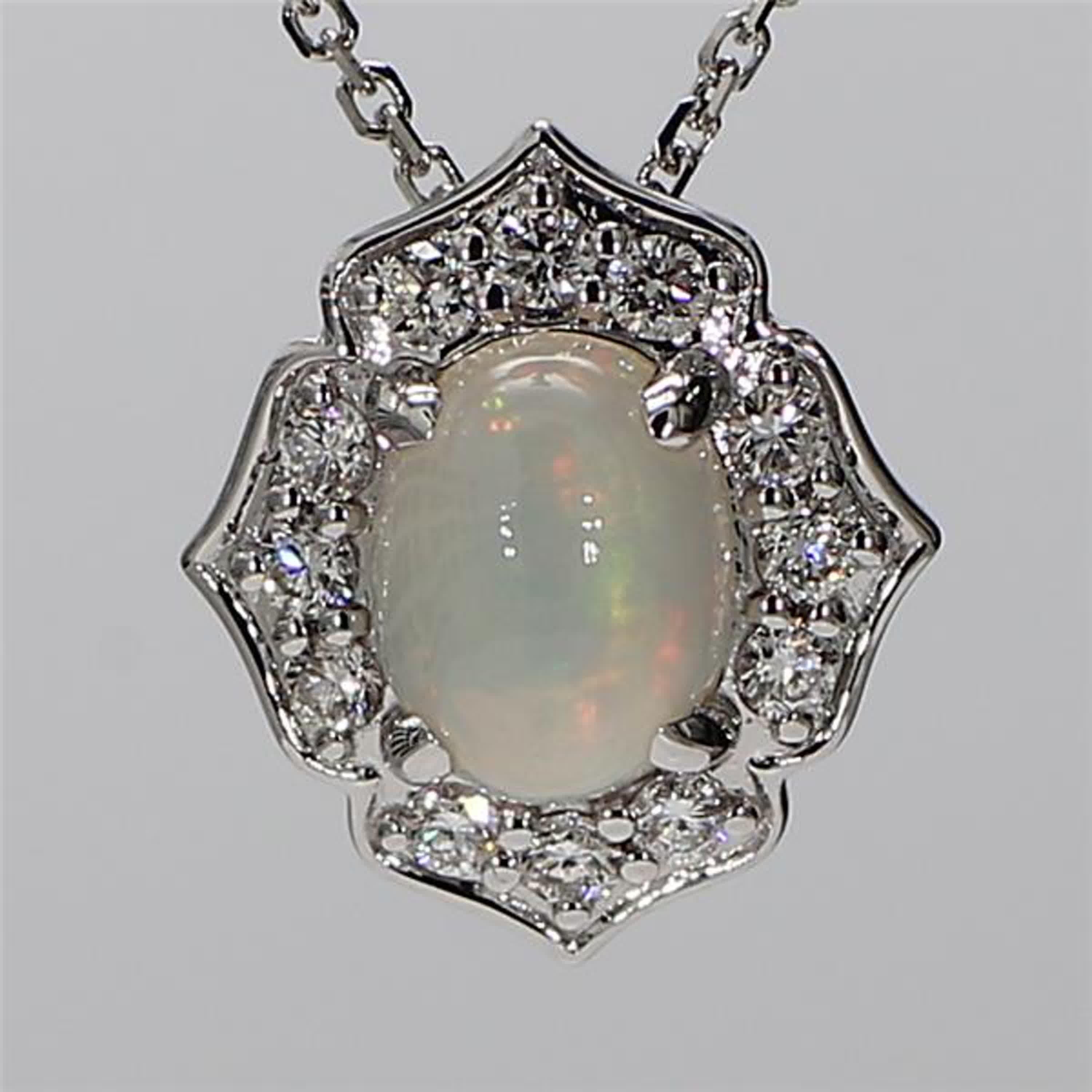 RareGemWorld's classic opal pendant. Mounted in a beautiful 18K White Gold setting with a natural oval cut opal. The opal is surrounded by natural round white diamond melee. This pendant is guaranteed to impress and enhance your personal