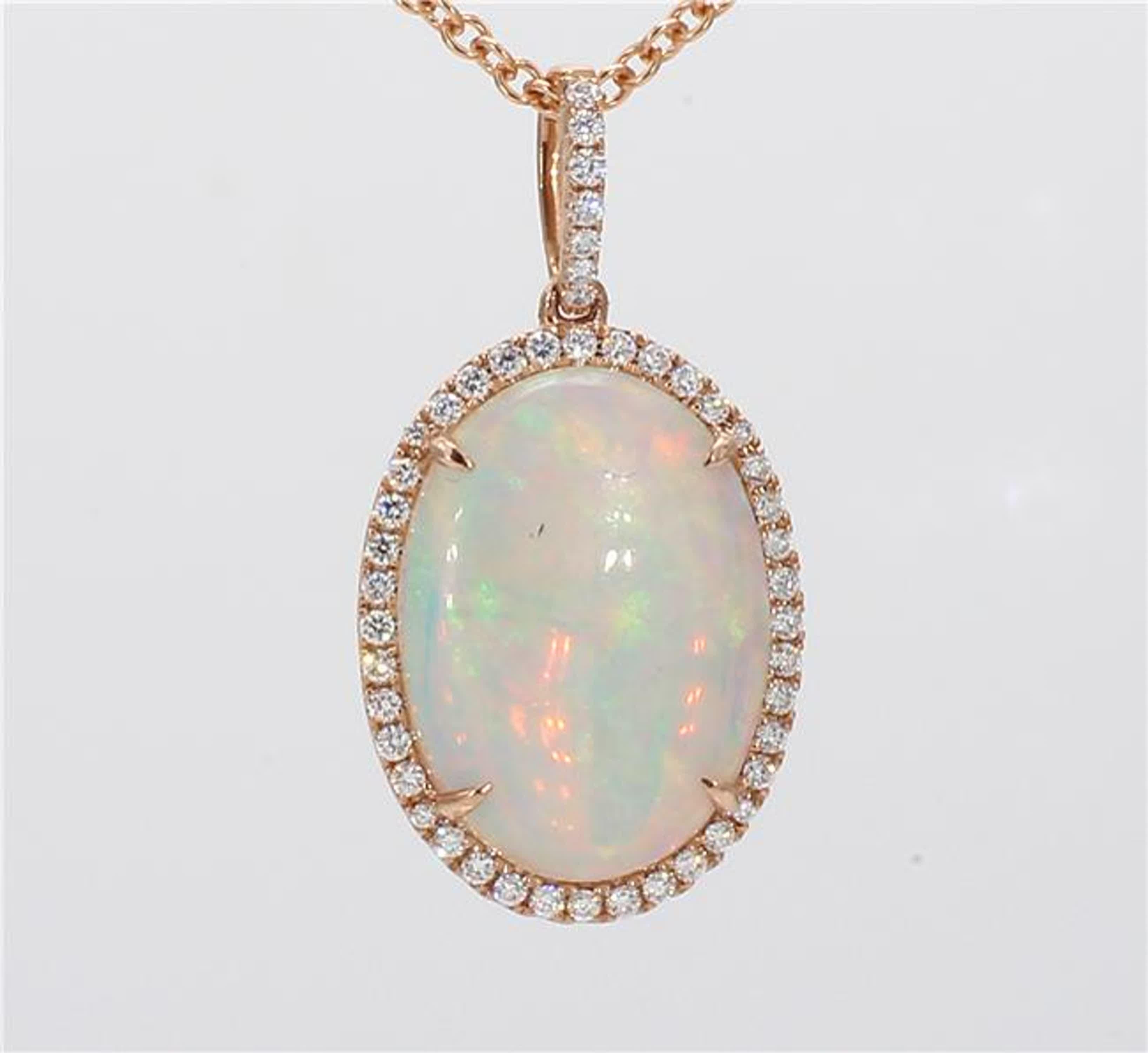 RareGemWorld's classic opal pendant. Mounted in a beautiful 14K Rose Gold setting with a natural oval cut opal. The opal is surrounded by natural round white diamond melee. This pendant is guaranteed to impress and enhance your personal