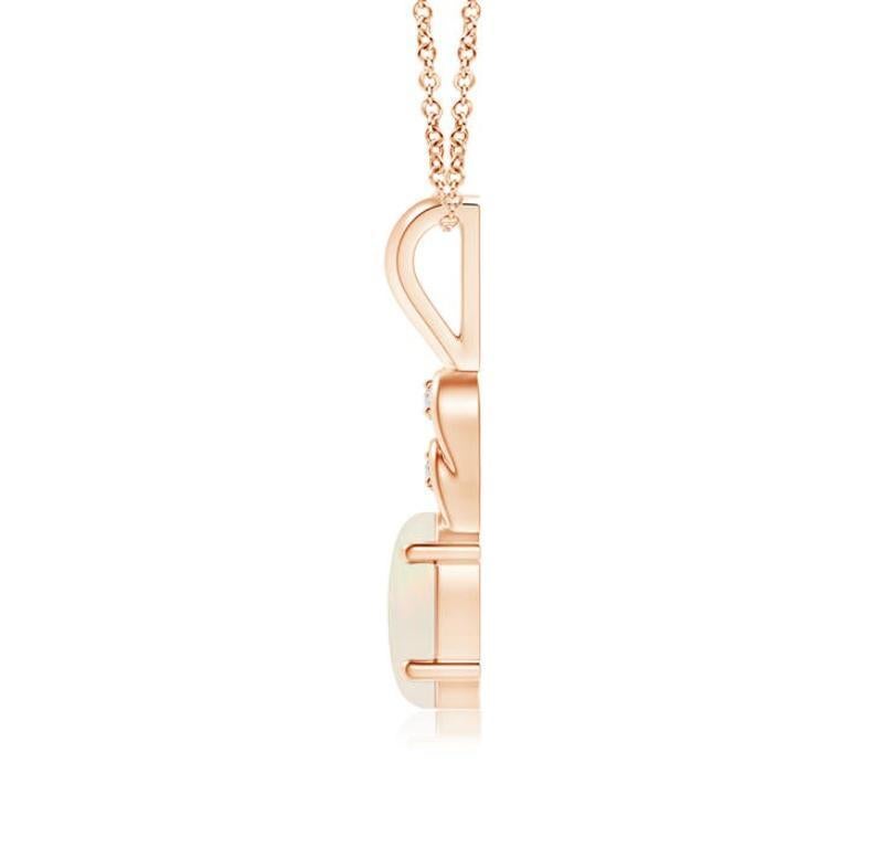 An oval opal hangs gracefully from the 14K rose gold metal bale exuding remarkable brilliance. The loops above the stone are adorned with shimmering diamond accents that elevate the beauty of this classic opal pendant. Available in different carat