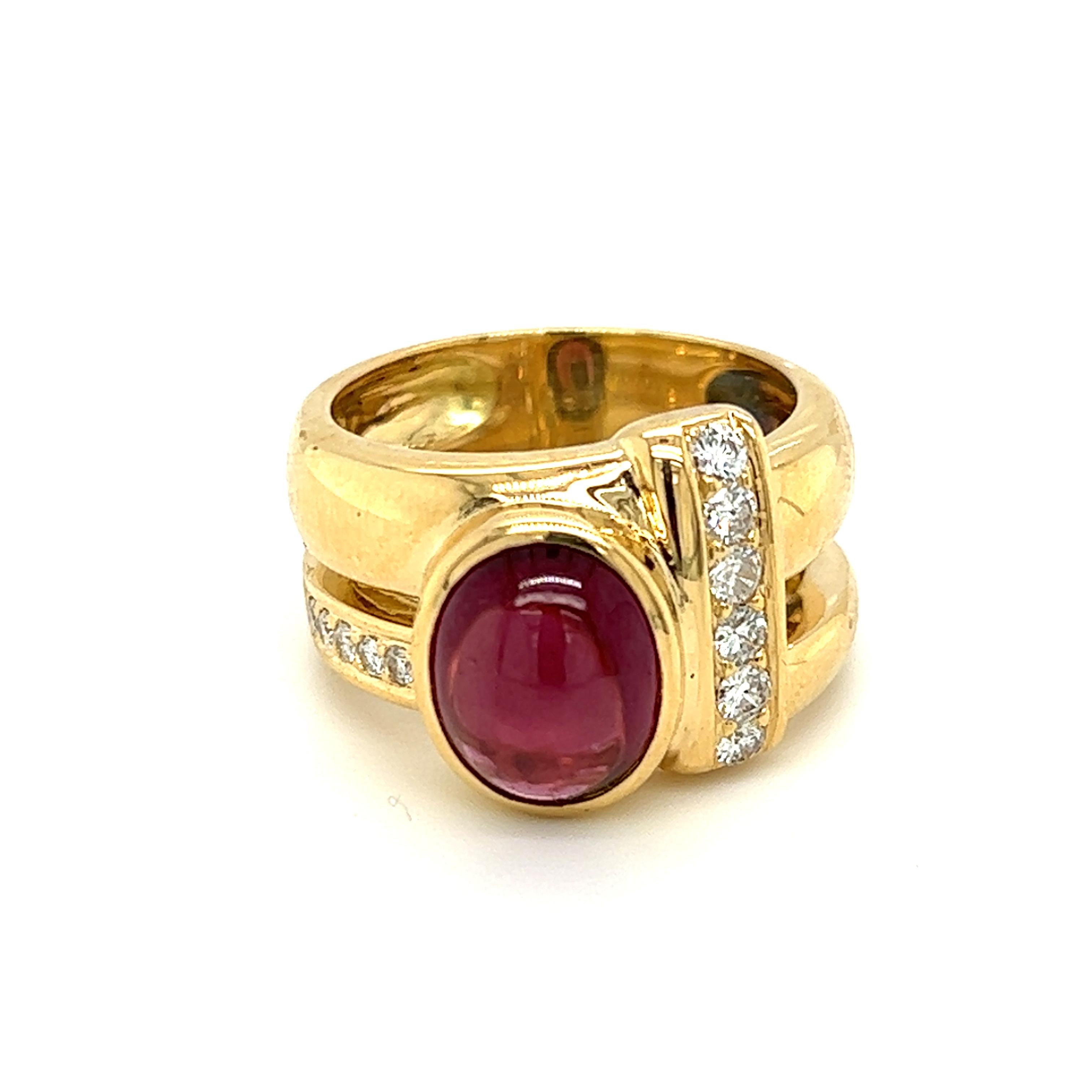One 18 karat yellow gold split shank design fashion ring, set with one (1) 10.1x7.8mm natural oval cabochon pink rhodolite garnet, and eleven (11) round brilliant cut diamonds, approximately 0.38 carat total weight with matching G/H color and SI1/2