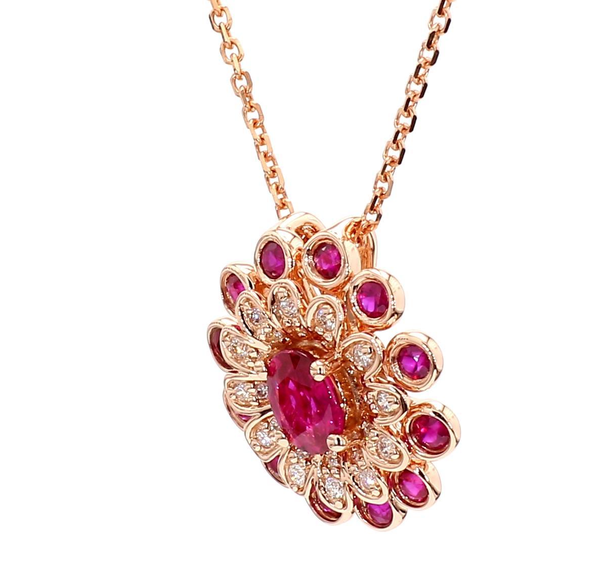 RareGemWorld's beautiful ruby pendant. Mounted in a beautiful 14K Rose Gold setting with a natural oval cut red ruby. The ruby is surrounded by natural round cut red ruby's & natural round cut white diamond melee. This pendant is guaranteed to