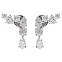 Boucles d
oreilles en or blanc 18 carats et diamants ovales et ronds, fabrication artisanale