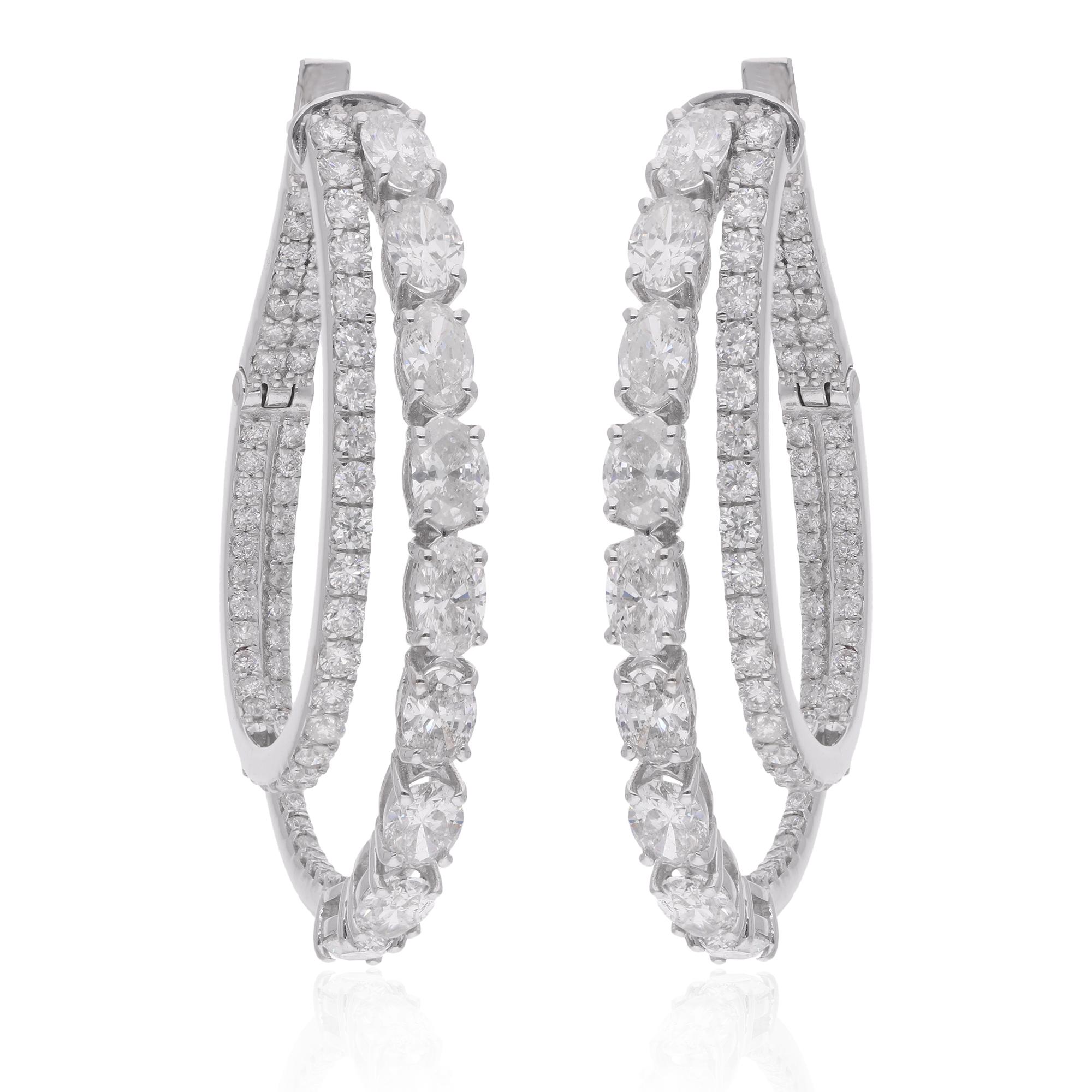 Immerse yourself in the timeless allure of these Natural Oval & Round Diamond Hoop Earrings, meticulously handcrafted in luxurious 18 Karat White Gold. These exquisite earrings are a testament to sophistication and elegance, destined to become a