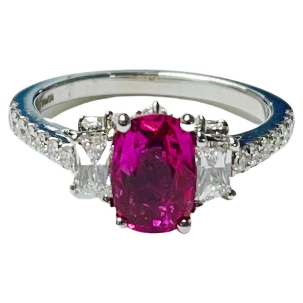 Natural oval ruby and diamond engagement ring hand crafted in 18k white gold. 

The details are as follows : 
Ruby weight : 1.62 carat 
Fancy shape diamond weight : 0.77 carat 
Small diamond weight : 1.01 carat 
Measurements : 11mm to 8.5mm ( ring