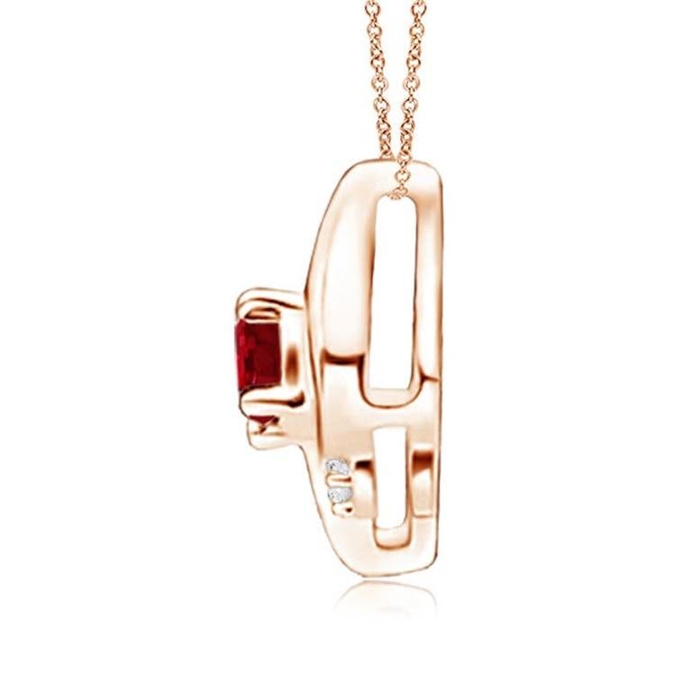 This gorgeous ruby solitaire pendant features an alluring conch-like frame within which sits a prong set, purplish red ruby. Sparkling round diamond accents add to the overall allure of the design. This tilted oval ruby pendant is designed in