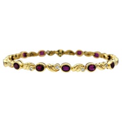 Pulsera Línea Rubí Ovalado Natural y Diamante Redondo en Oro Amarillo de 18 Kilates