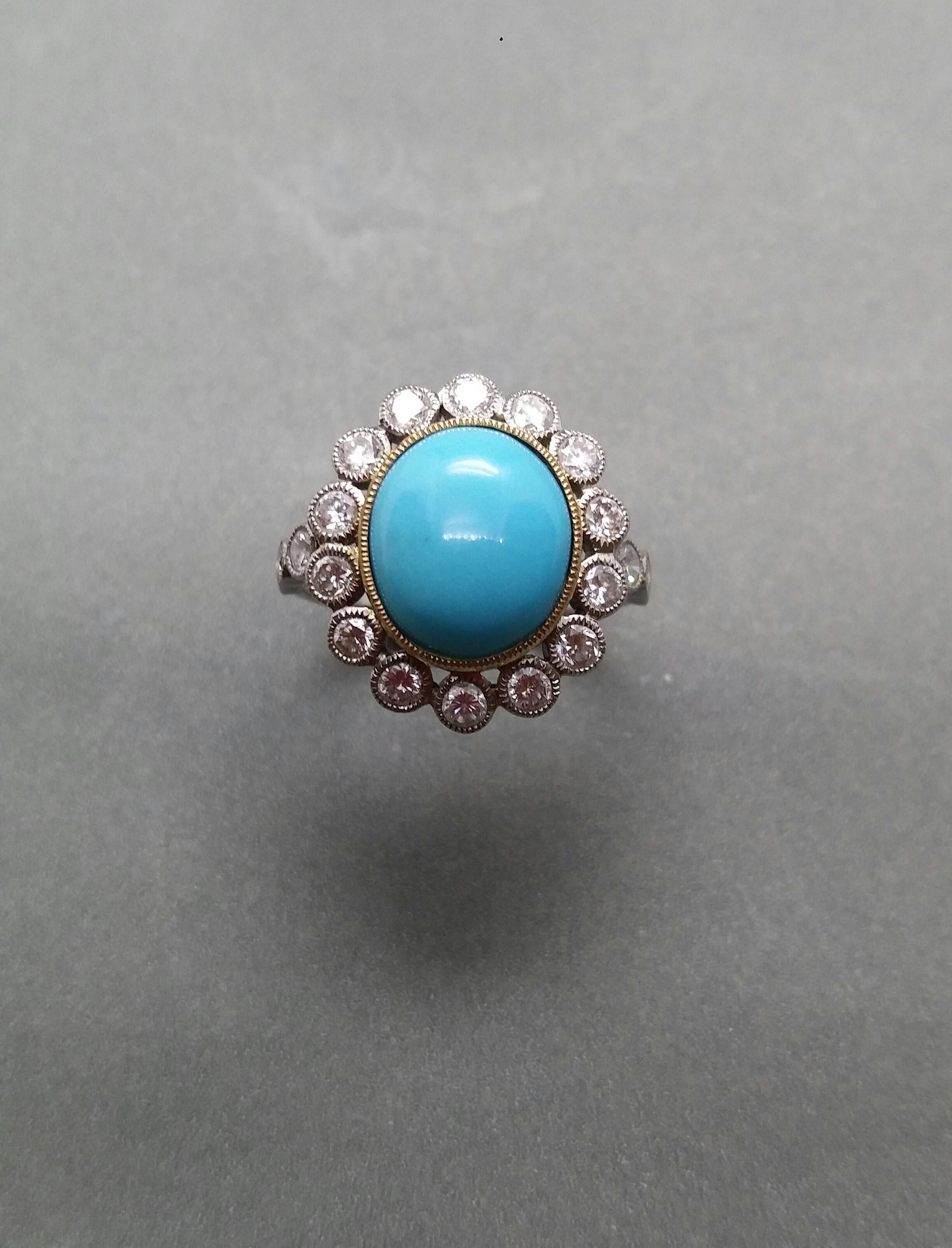 Classic ring with an oval Turquoise measuring 10x12 mm. set in a yellow gold bezel and surrounded by 14 full cut round diamonds of 0,06 cts each set in 14 kt white gold. Each side of the shank has 3 full cut diamonds set in 14 kt white gold.

In