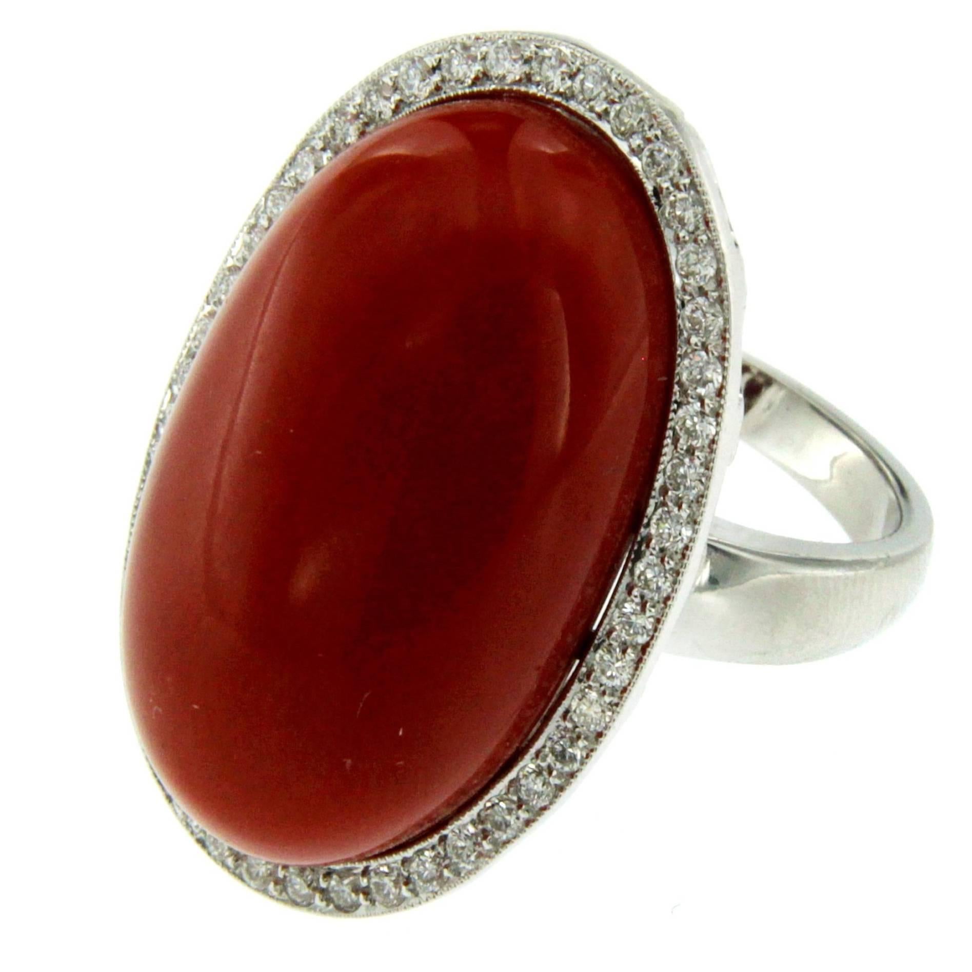 Truly exclusive vintage ring out from 1960s origin Italy, hand crafted of solid 18Kt white gold. 
The ring features a Natural Cabochon Mediterranean Coral, of the greatest quality, 100% natural not dyed or worked with any resin or other synthetic