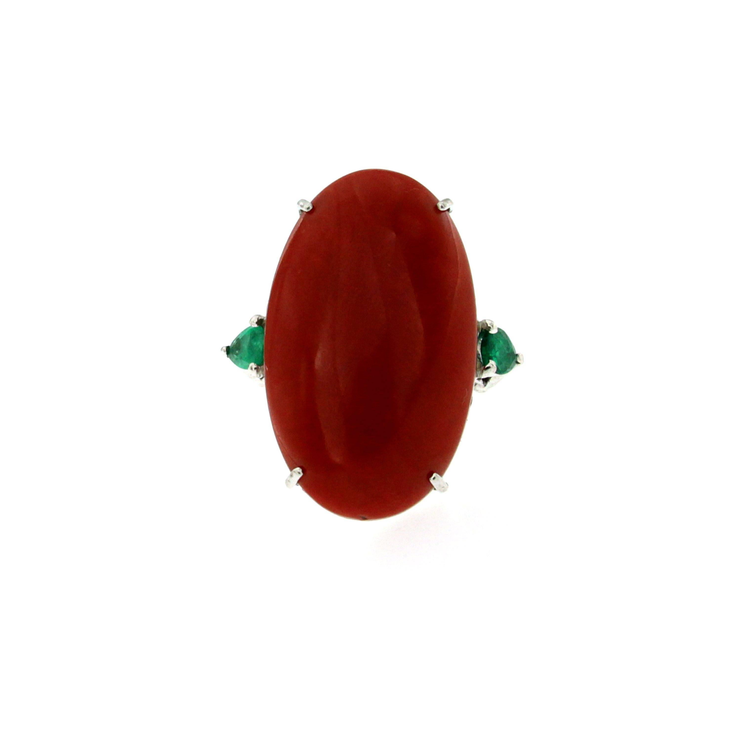 Beautiful vintage ring out from 1970s origin Italy, hand crafted of solid 18Kt white gold. 

The ring features a Natural Oval Cabochon Aka Japanese Coral, intense red color without imperfections, not dyed or worked with any resin or other synthetic