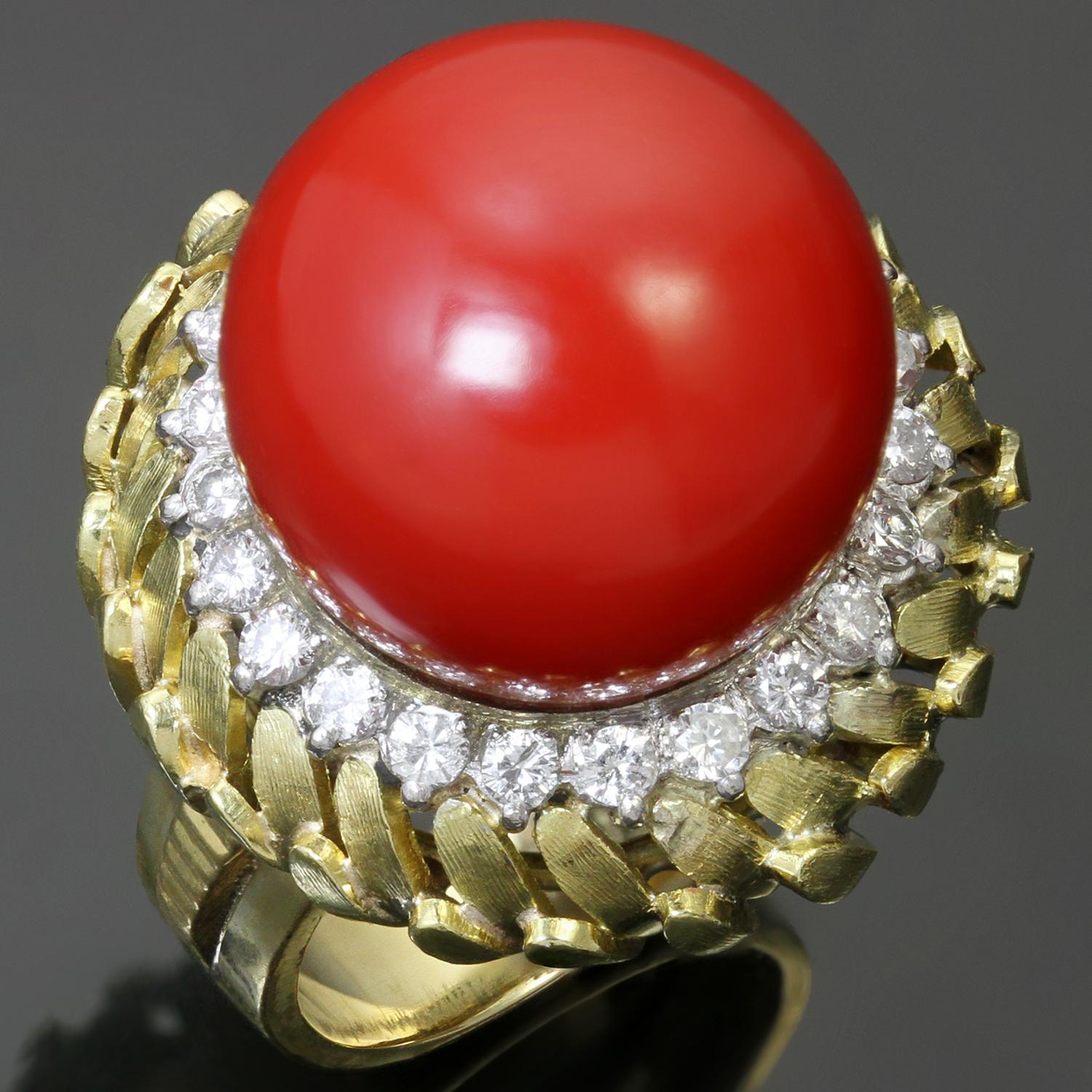 The gorgeous rare vintage ring is crafted in 18k yellow gold and features a sphere-shaped natural oxblood coral measuring 16.50mm x 15.55mm, accented with full-cut diamonds weighing an estimated 0.70 carats, set in 18k white gold. Made in United