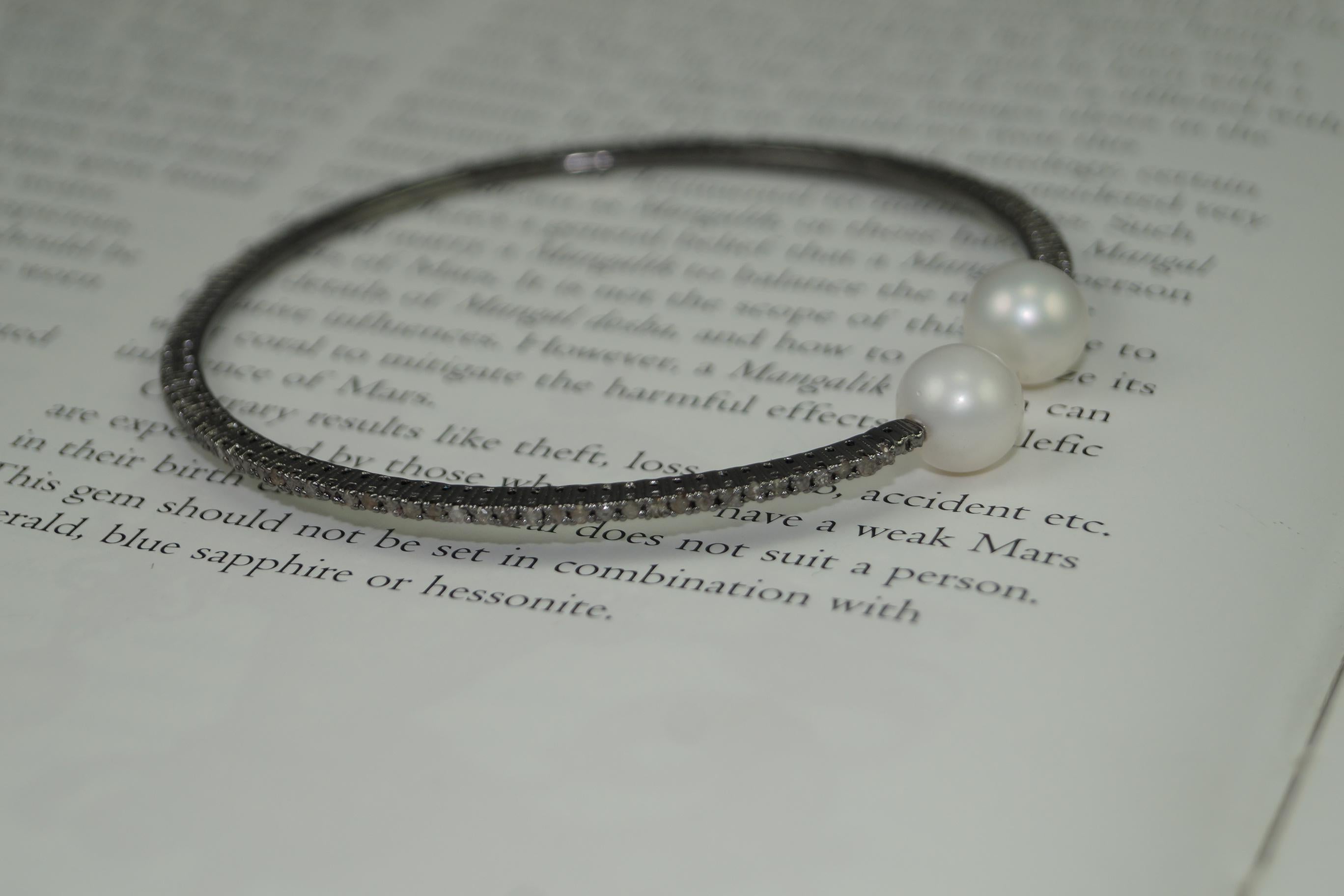 This elegant diamond pearl handcuff consists of:

Diamond- 1.10cts
Diamond type: Pave diamonds
Diamond color: White 
Diamond Certificate- Certified Natural
Metal: Silver
Metal Purity: Sterling Silver or 92.5% Pure
Color of silver- Oxidized silver