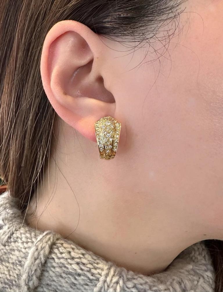 Pave Diamond Half Hoop Earrings 1.10 cttw in 18k Yellow Gold 

Diamond Half Hoop earrings feature a Shield Motif with Round Brilliant Diamonds on each earrings, all set in 18k Yellow Gold. The earrings are secured with Omega clips.

Total diamond