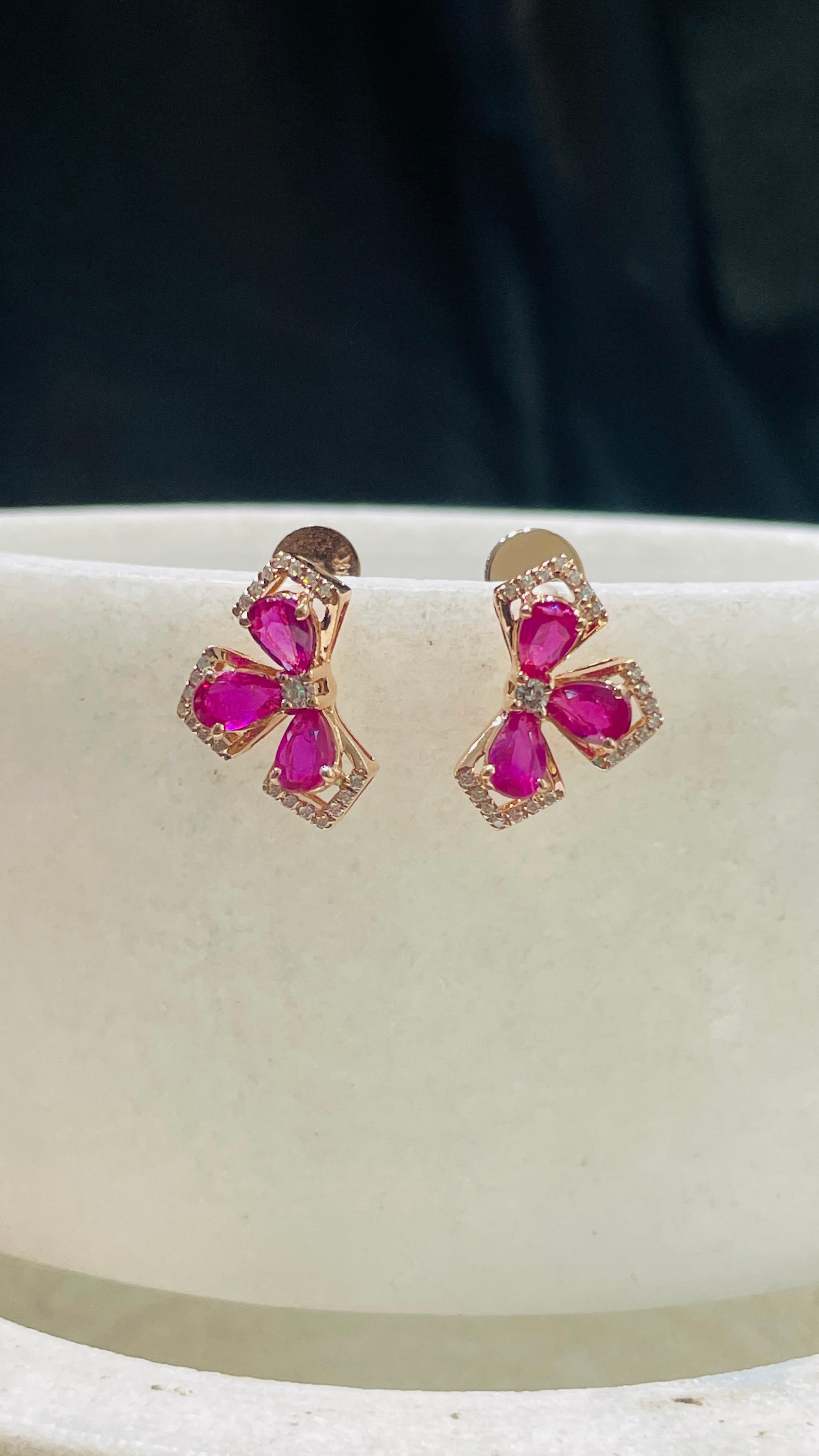 Earrings create a subtle beauty while showcasing the colors of the natural precious gemstones and illuminating diamonds making a statement.

Pear cut Ruby earrings in 14K gold. Embrace your look with these stunning pair of earrings suitable for any