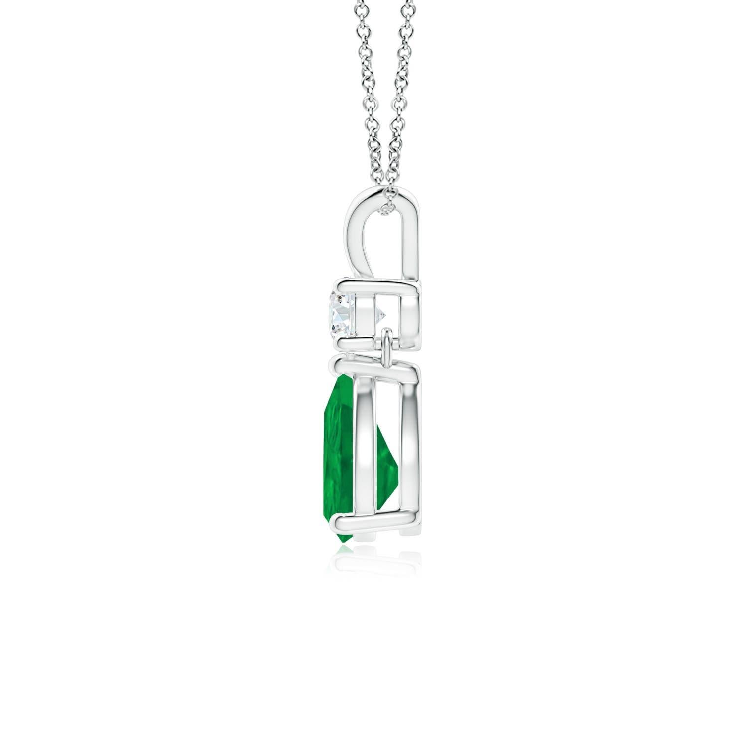 A vivid green pear cut emerald dangles from a sparkling white diamond on this elegant drop pendant. The lustrous V bale adds beauty to this 14k white gold emerald and diamond pendant. It exudes luxurious charm with its remarkable long drop