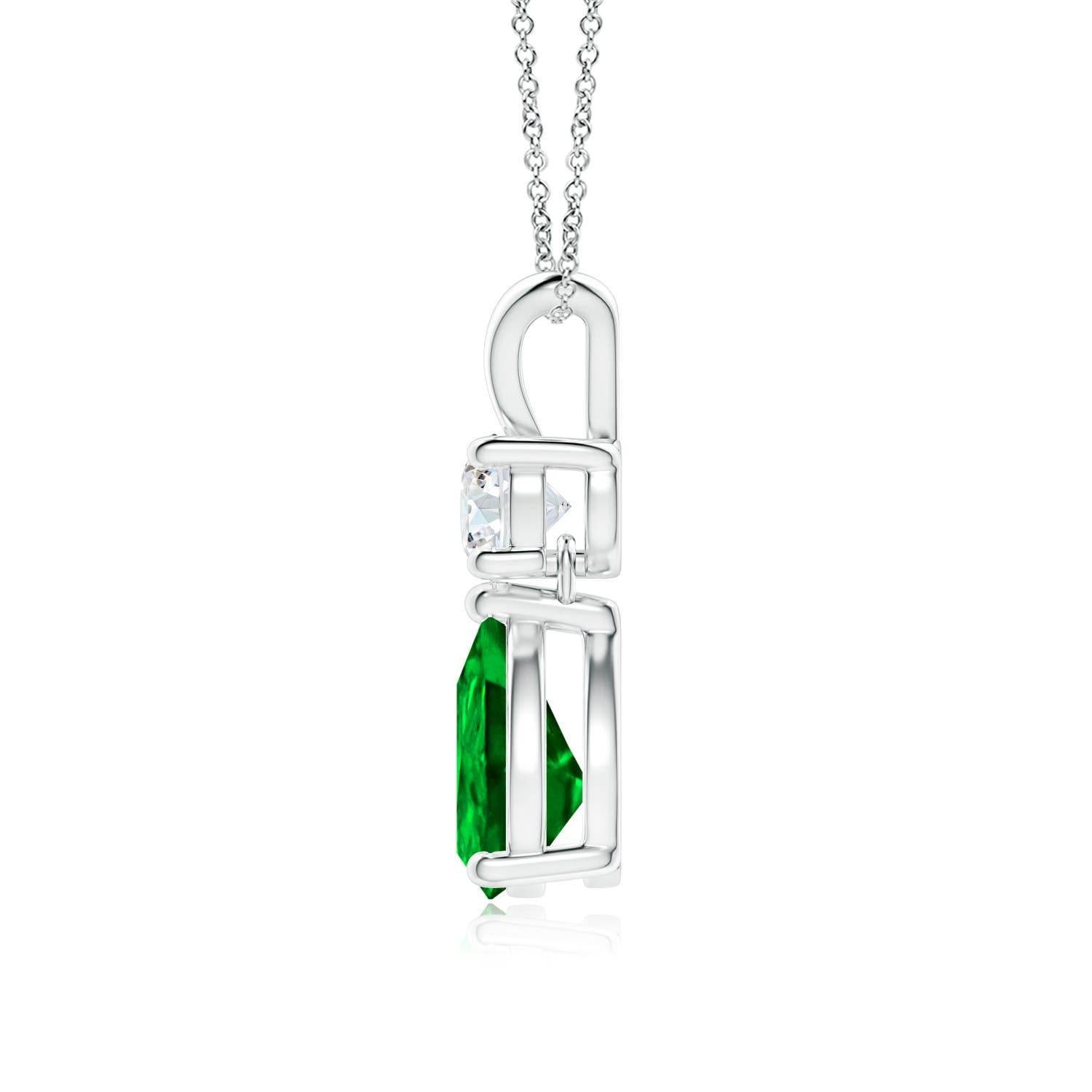 A vivid green pear cut emerald dangles from a sparkling white diamond on this elegant drop pendant. The lustrous V bale adds beauty to this 14k white gold emerald and diamond pendant. It exudes luxurious charm with its remarkable long drop