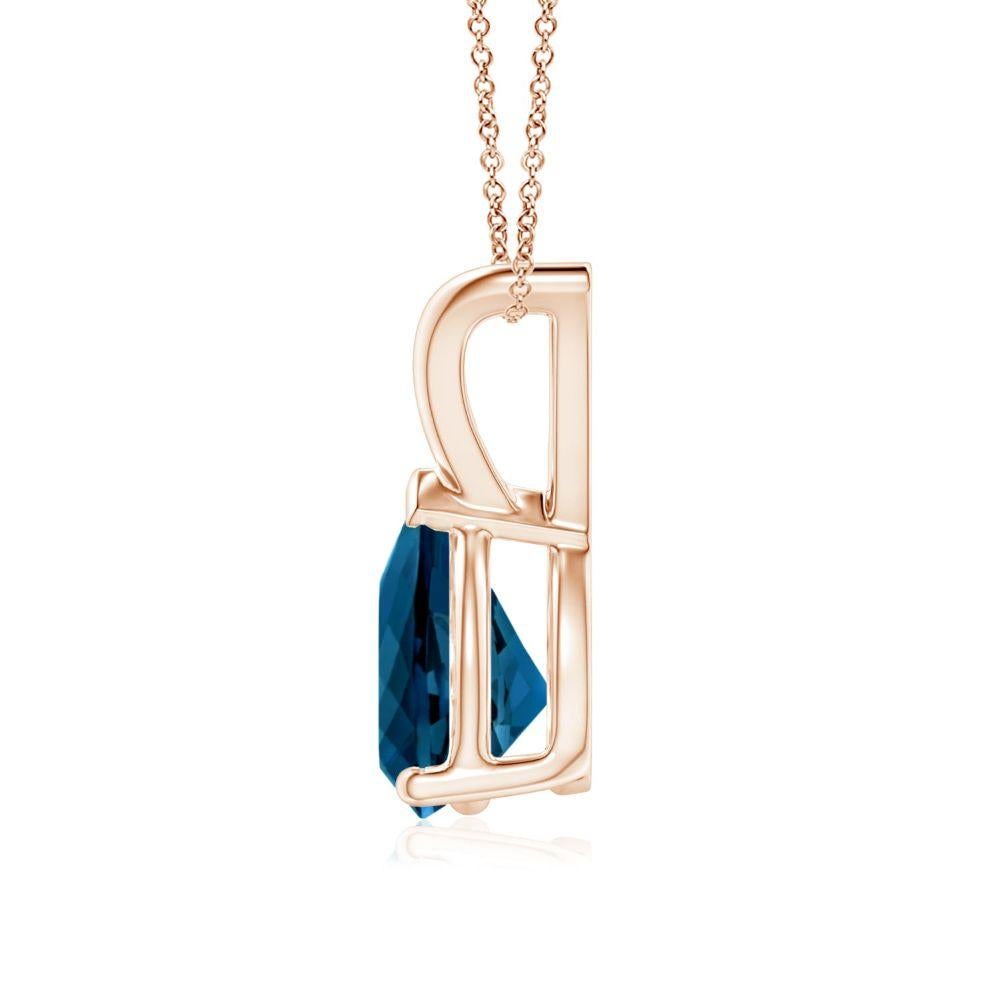Suspended from a lustrous V bale is a vibrant pear-shaped London blue topaz. It is held in a three prong setting with a V prong securing the tapering tip. Crafted in 14k rose gold, this classic solitaire London blue topaz pendant allures with its