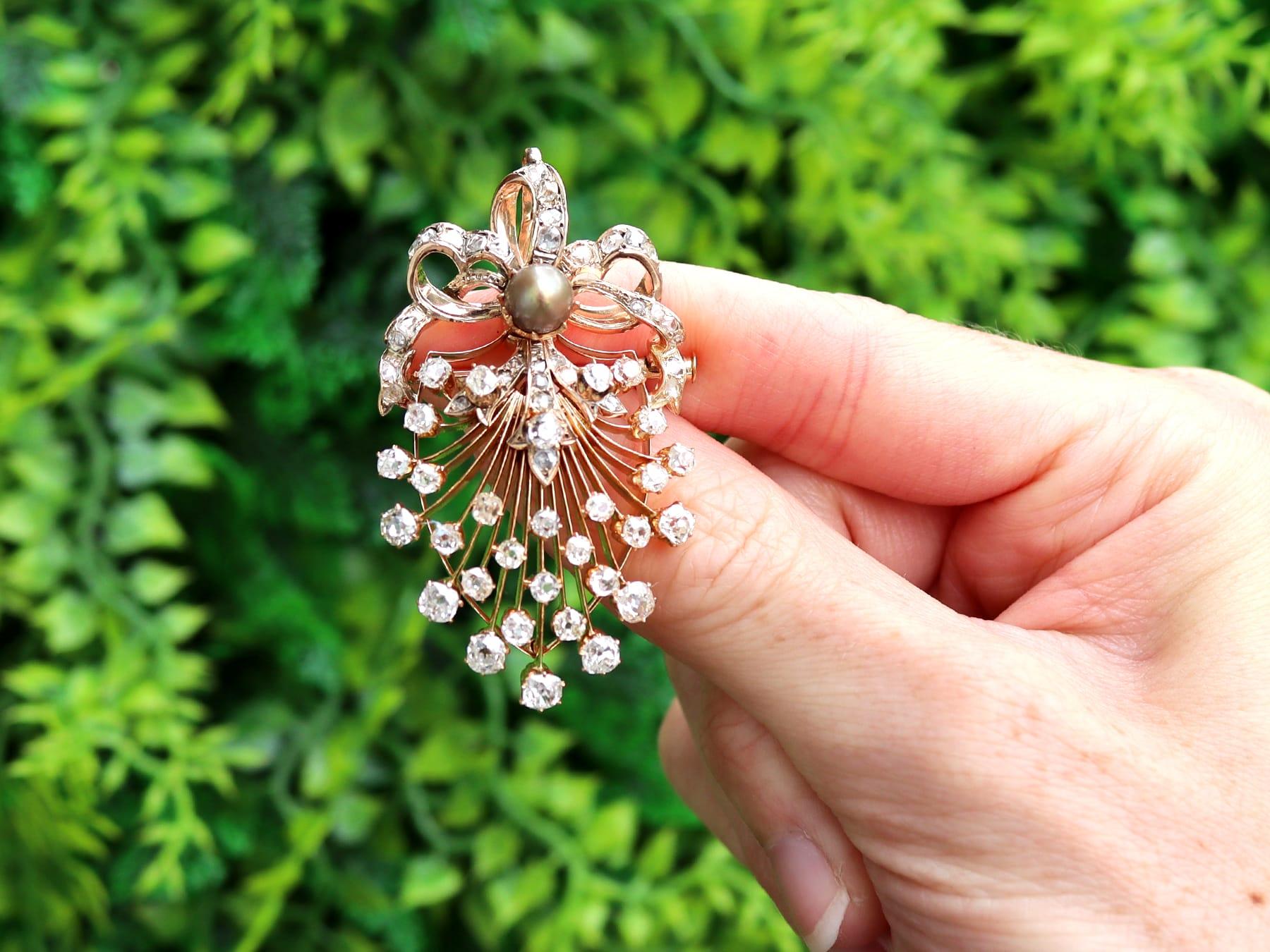 A stunning, fine and impressive antique Victorian natural pearl and 4.84 carat diamond, 18 karat yellow gold pendant/brooch; part of our Victorian jewelry collection.

This stunning, fine and impressive antique Victorian pendant/brooch has been