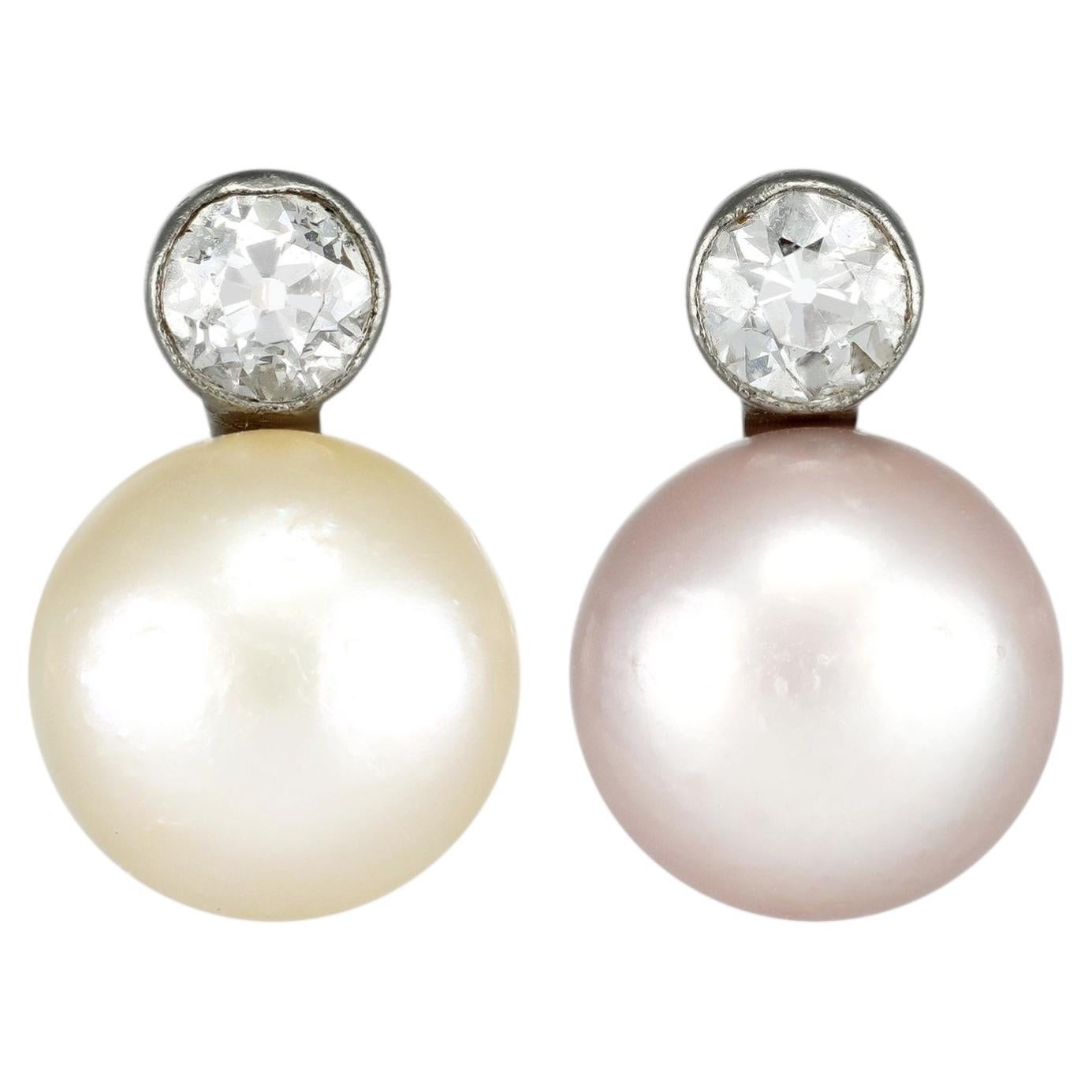 Natural pearl and diamond drop earrings, circa 1920.