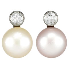 Natural pearl and diamond drop earrings, circa 1920.