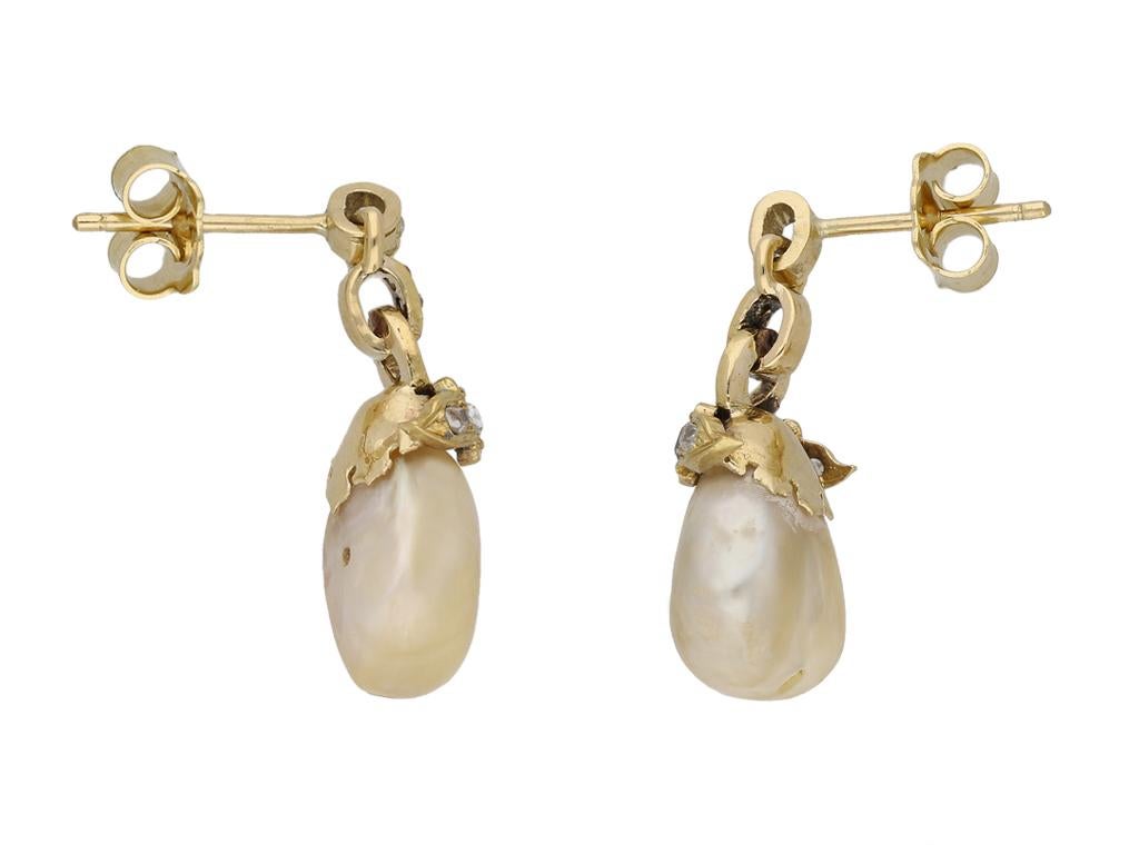 Natural pearl and diamond earrings. A matching pair of earrings, each suspending a drop shape natural saltwater pearl, the surmount set with eleven cushion shape single cut diamonds in open back grain settings, all twenty two with a combined