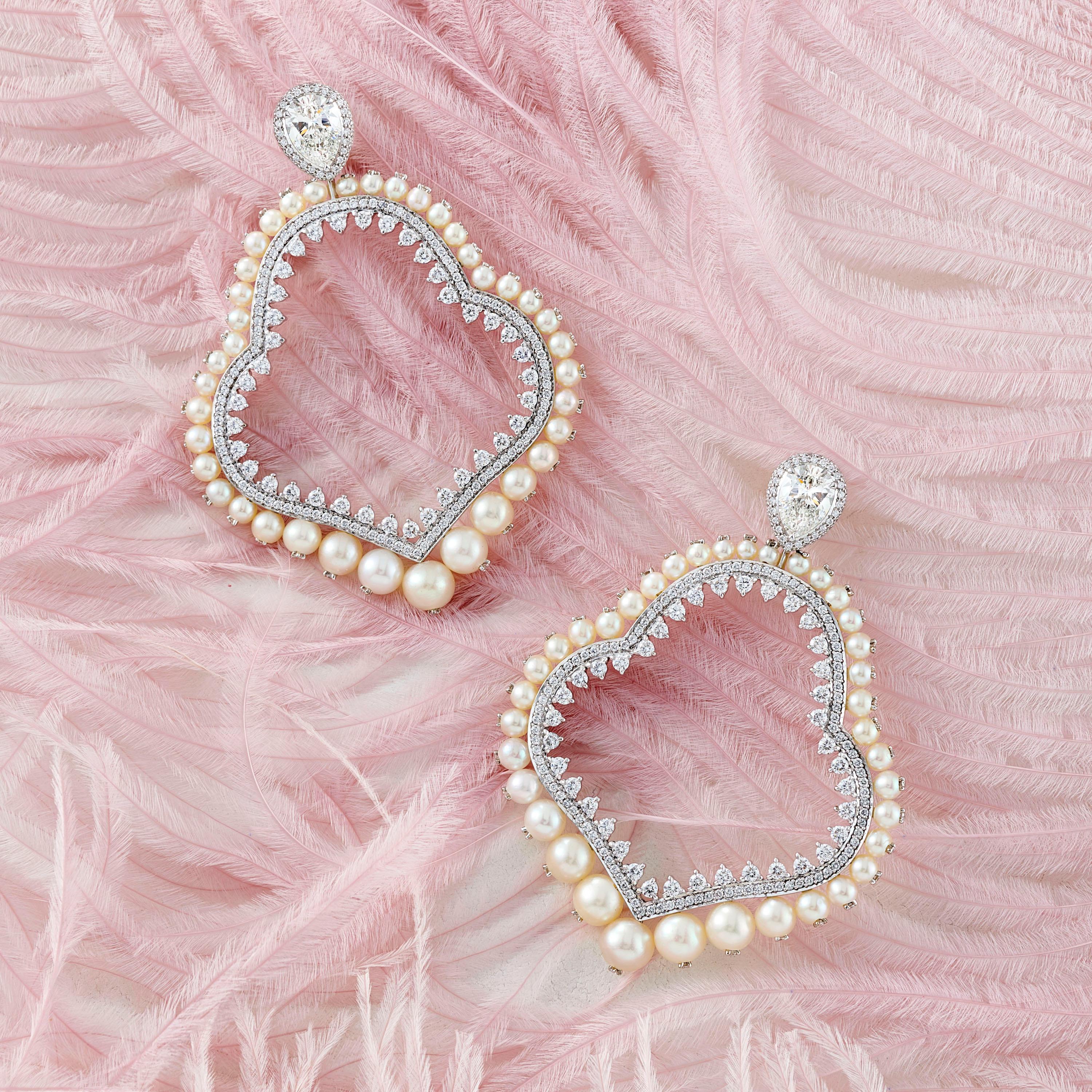 A Pair of Natural Pearl and Diamond Gold Earrings by Jewelry Designer, Sarah Ho.

Natural Pearls (76 pcs) from an antique Basra Pearl necklace with two pear cut H VS diamonds of 1.01ct and 1ct and 3.36ct round diamonds set in 18kt white gold.  The