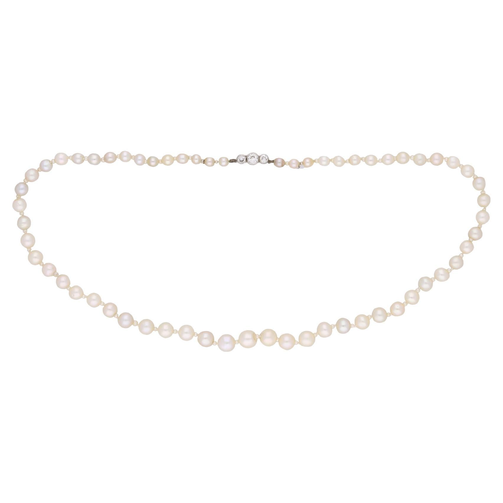Natural pearl and diamond necklace, circa 1910.  For Sale