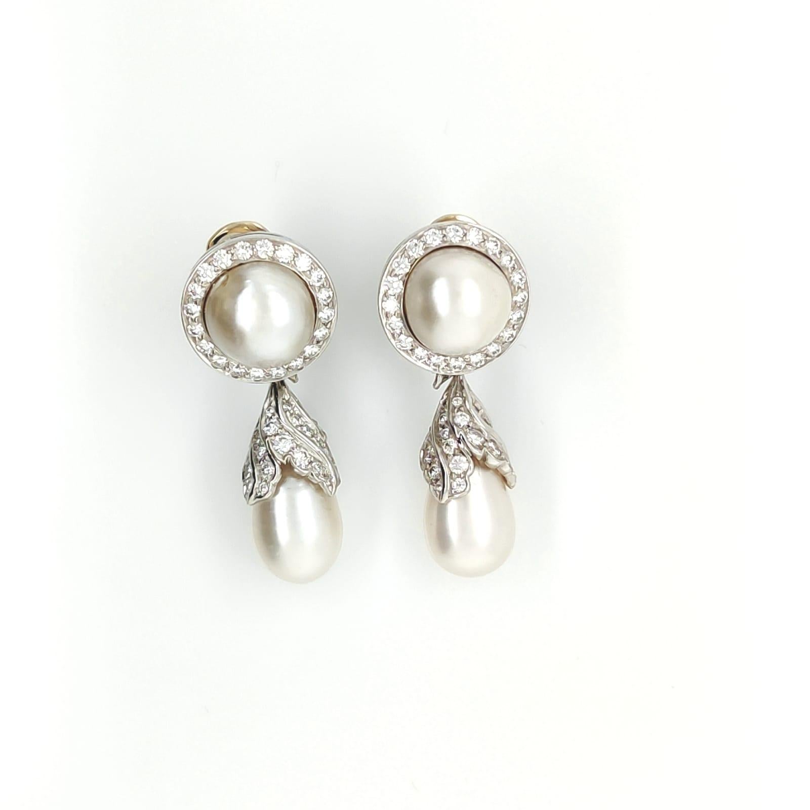 These Natural Pearl and Diamonds Drop Earrings in Platinum are a stunning piece of jewelry that exudes elegance and sophistication. The earrings feature natural pearls and diamonds set in platinum, a precious metal that adds to the luxuriousness of