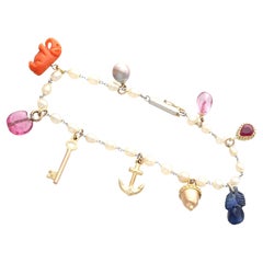 Pulsera antigua con dijes de zafiro, turmalina, topacio y rubí