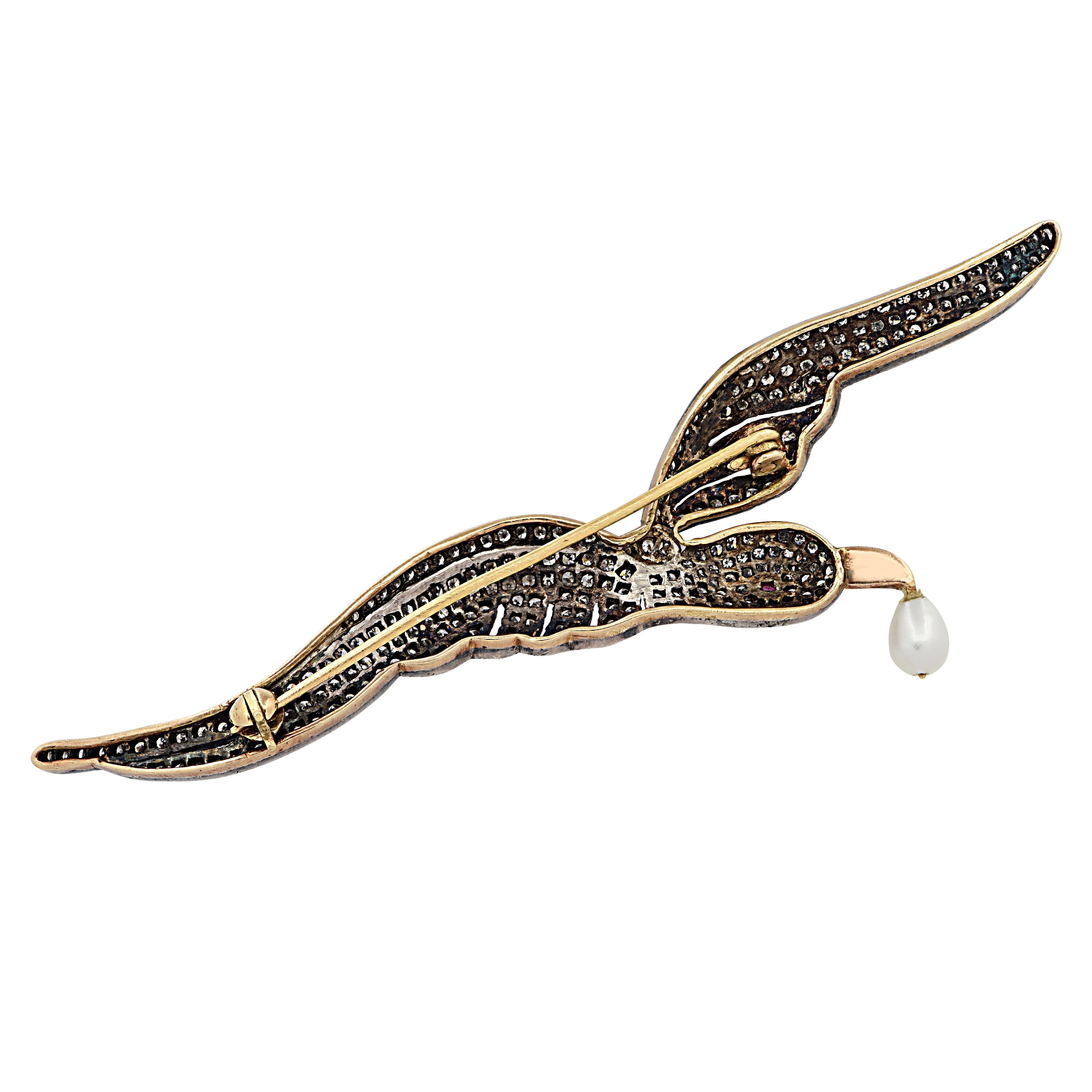 Bird Brooch Pin crafted in silver and yellow gold depicting a bird in full flight, encrusted with 270 single cut diamonds weighing approximately 3 carats total, H-J color, SI -I1 clarity. The bird, detailed with milgrain and open metal work, has a