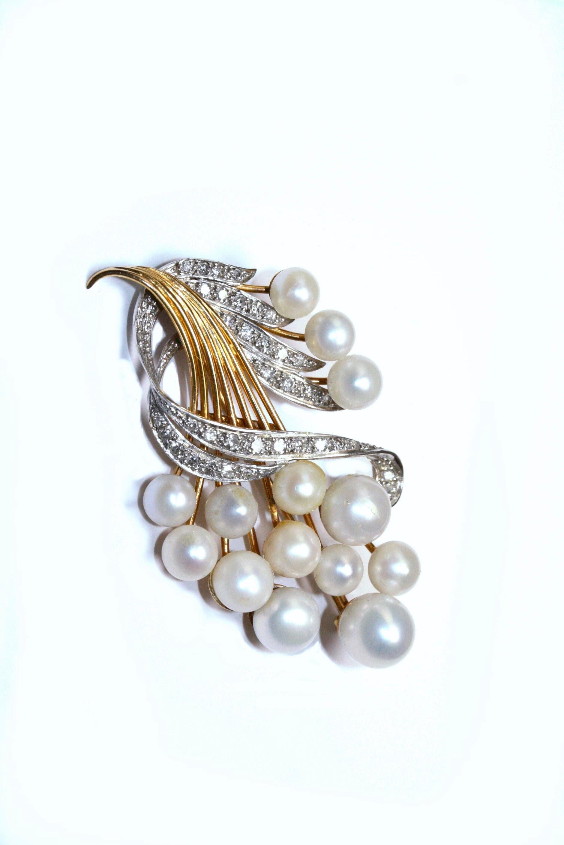 A brooch  in the form of a spray set with Scottish natural river pearls. The brooch is set with 14 pearls measuring 7.85mm to 5.3mm diameter and 37 single cut diamonds measuring from 1.55mm to 1.1mm. The total diamond weight is .25ct. The brooch