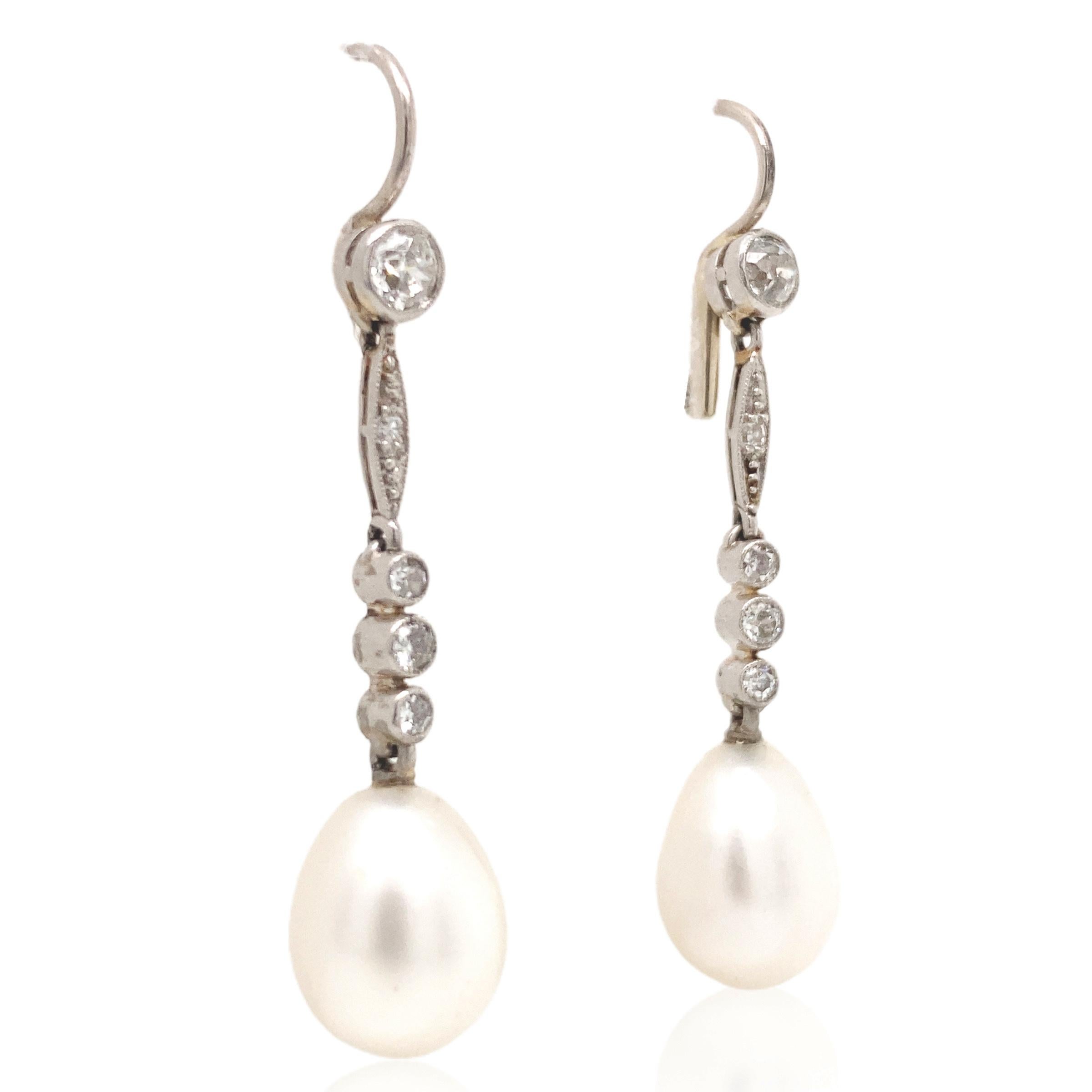 This pair of elegant natural pearl and diamond earrings features a slender, graceful design, highlighting their unique luster and natural beauty. Each pearl is adorned with exquisite diamonds, with a total weight of approximately 0.38ct, adding