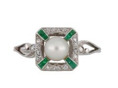 Natural pearl, emerald and diamond ring, circa 1915. 