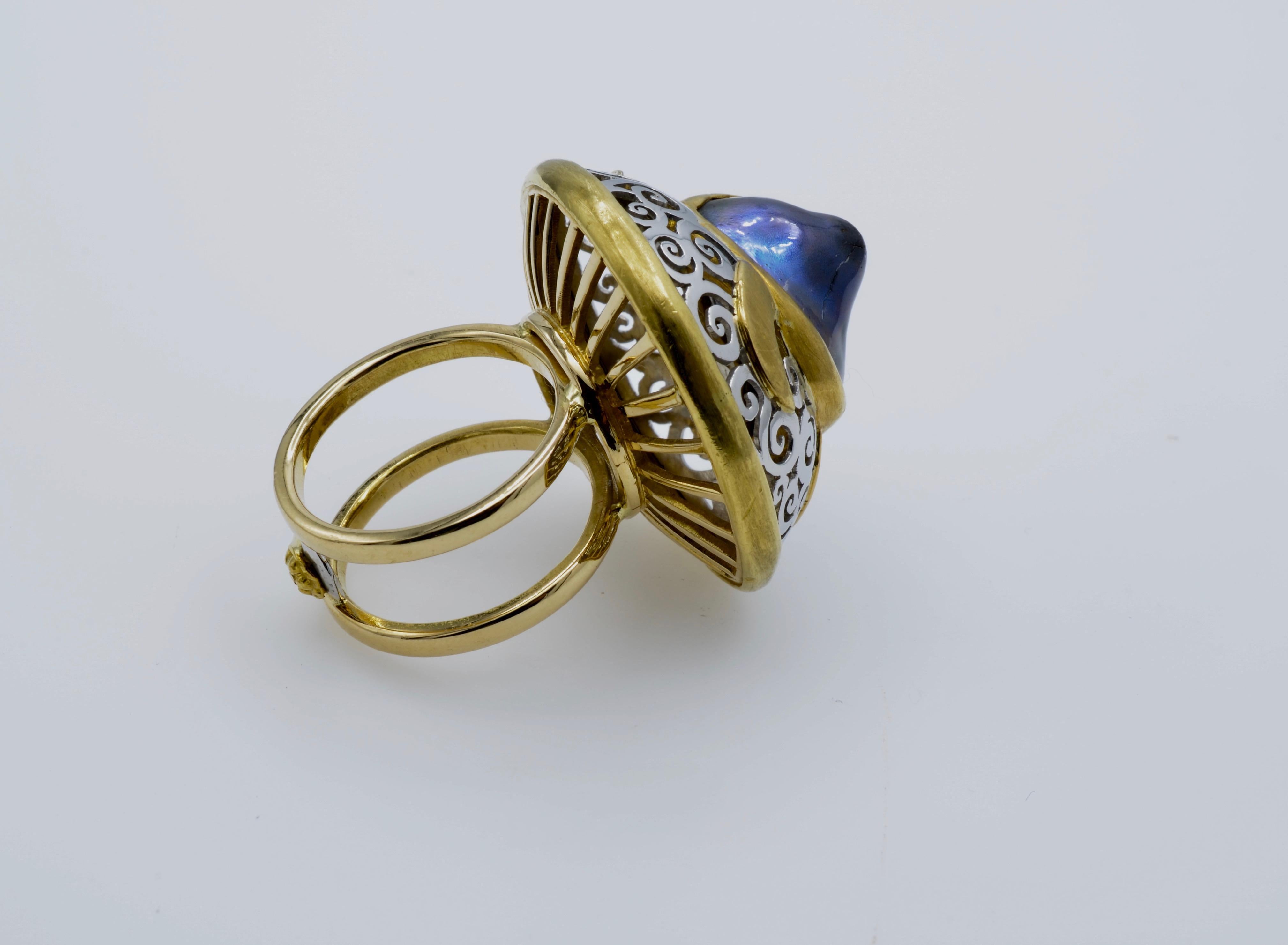 This ring is a 'wedding cake' of natural pearl and yummy gold accented with swirls of hand carved platinum. There is an intricate basket under the pearl that gives it a light and airy lift. A very unique ring that is a conversation starter! The ring