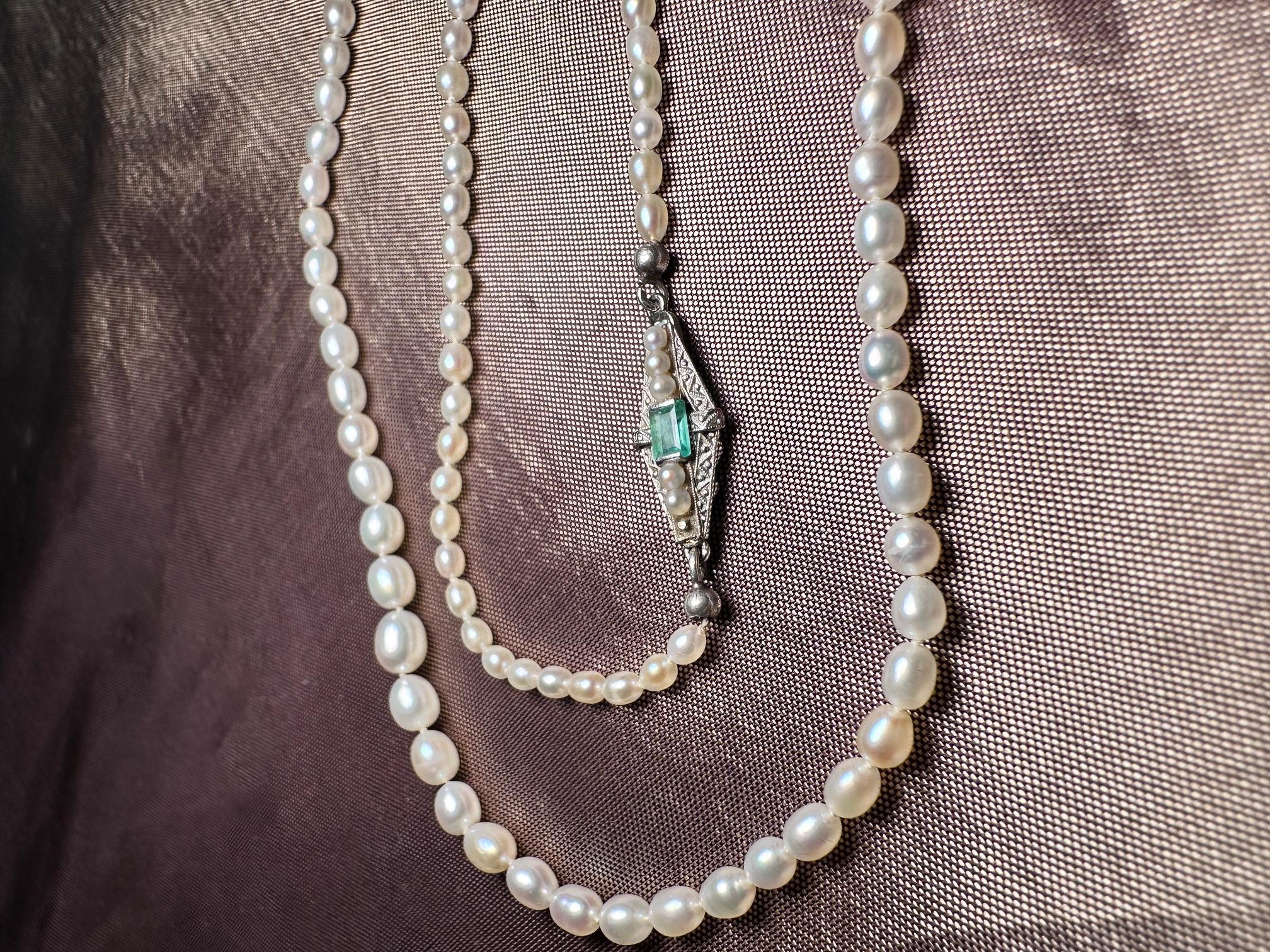 A beautiful and elegant natural pearl necklace with an emerald and old cut diamond clasp. 

It comes with a certificate.